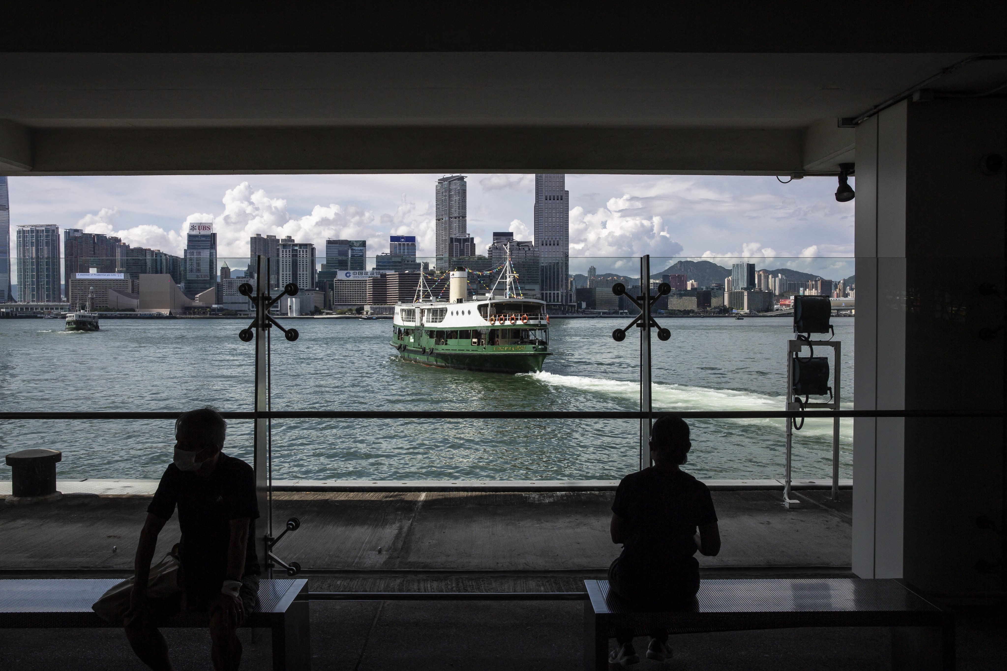 People wait for a Star Ferry to cross Victoria Harbour in Hong Kong on August 23. Photo: AFP