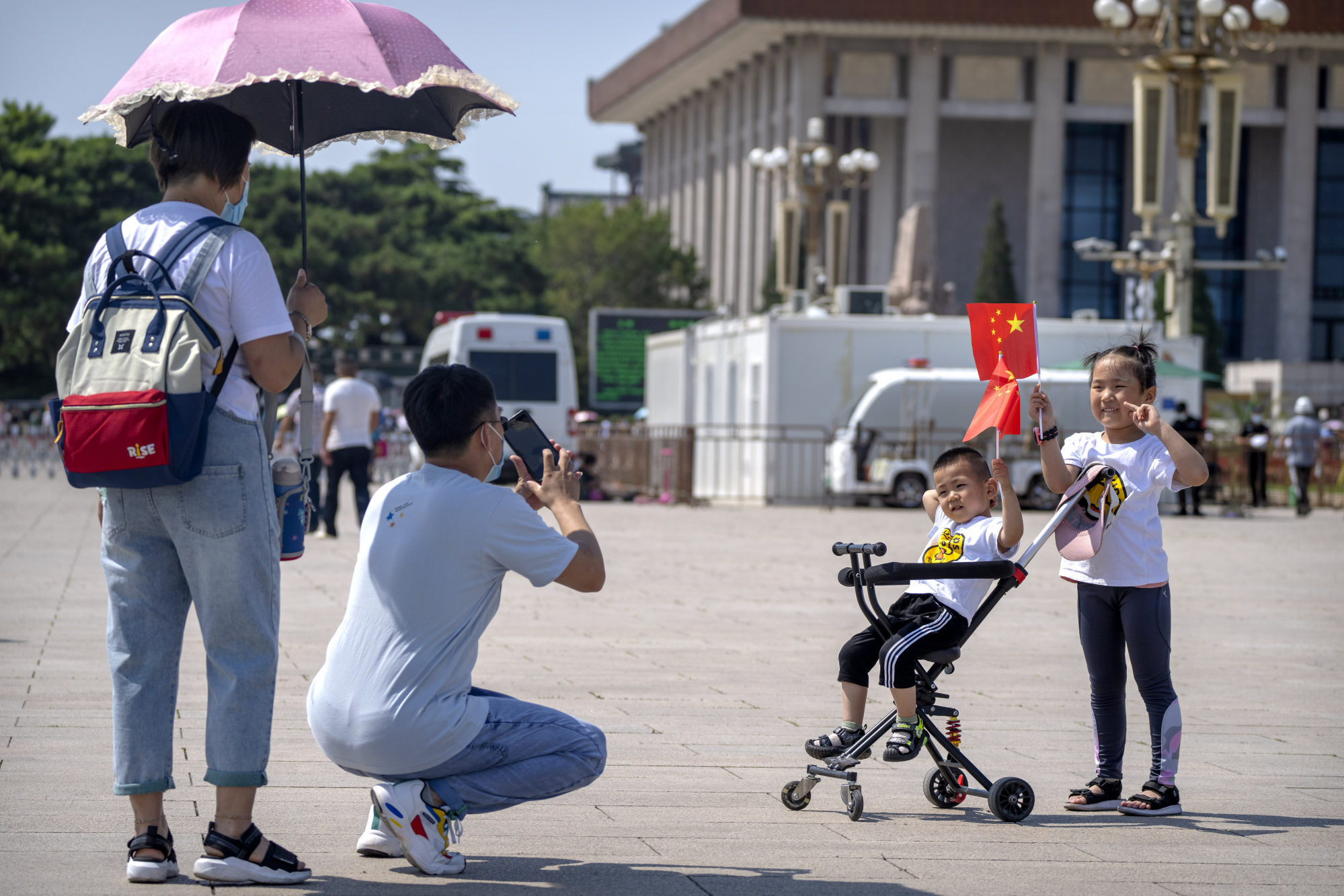 Children hold Chinese flags as they pose for a photo at Tiananmen Square in Beijing on June 22. China’s middle class now numbers more than 400 million. Photo: AP