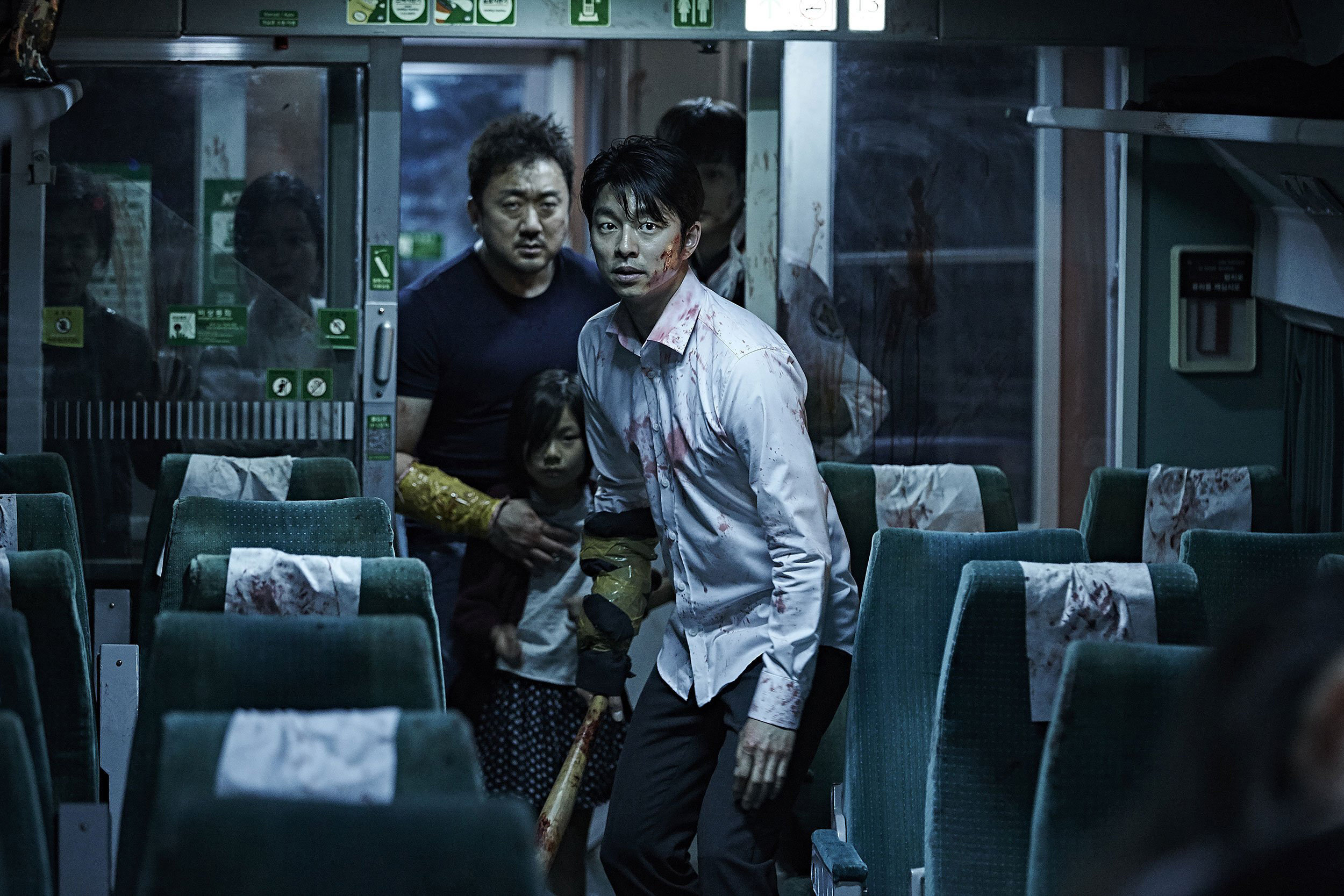 Gong Yoo (front) and Ma Dong-seok in a still from Train to Busan (2016).