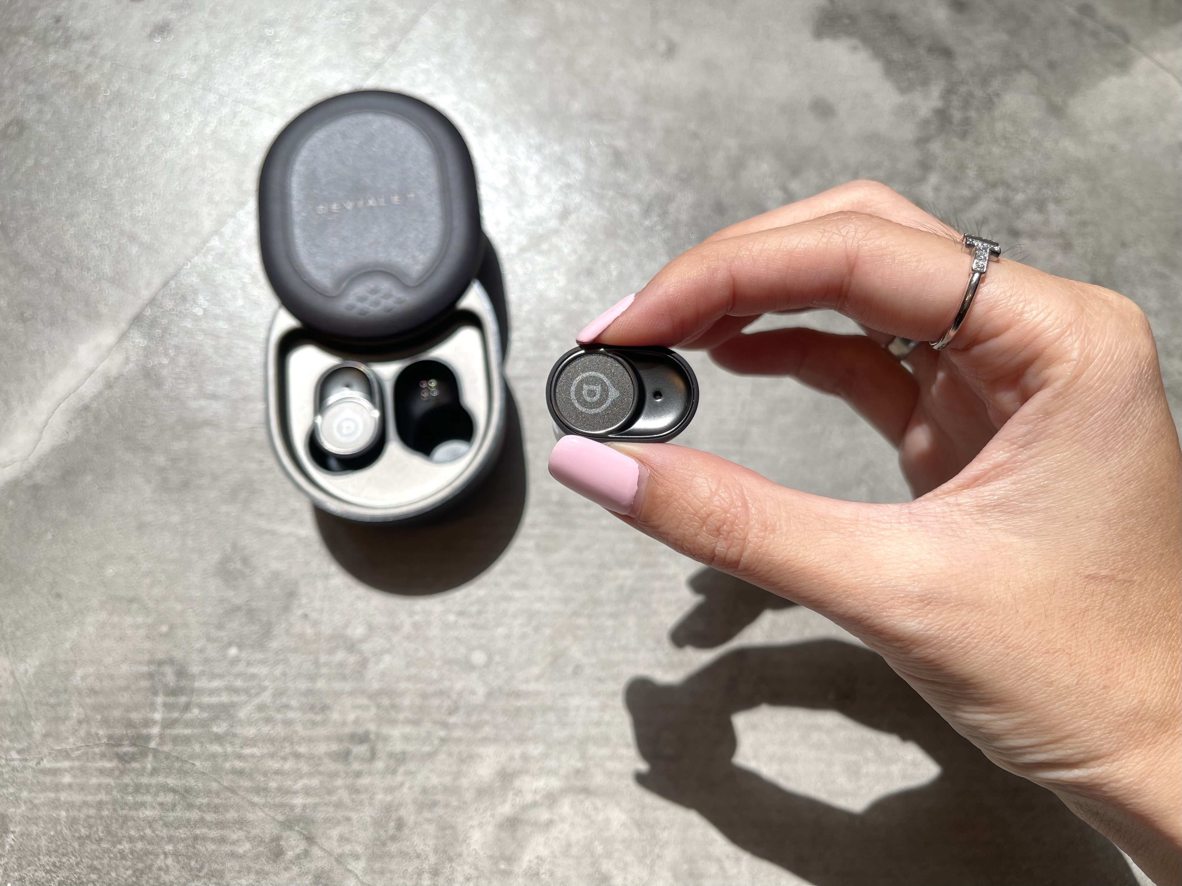 Devialet’s earbuds have a curved oval shape to them. Photo: STYLE