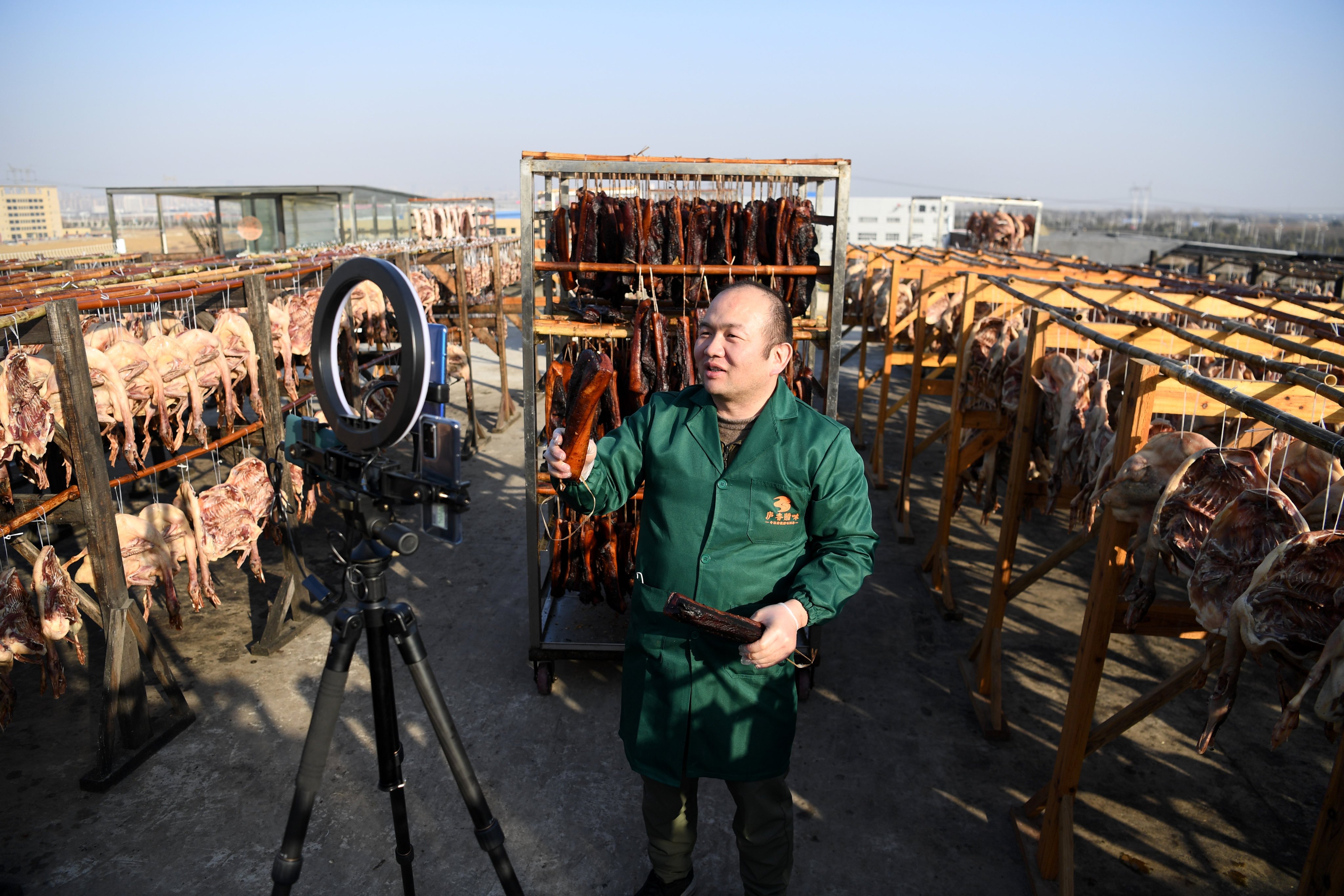 A man promotes cured meat via live streaming from his factory in Shangpai, Feixi county, in the eastern Chinese province of Anhui on January 13. Photo: Xinhua 