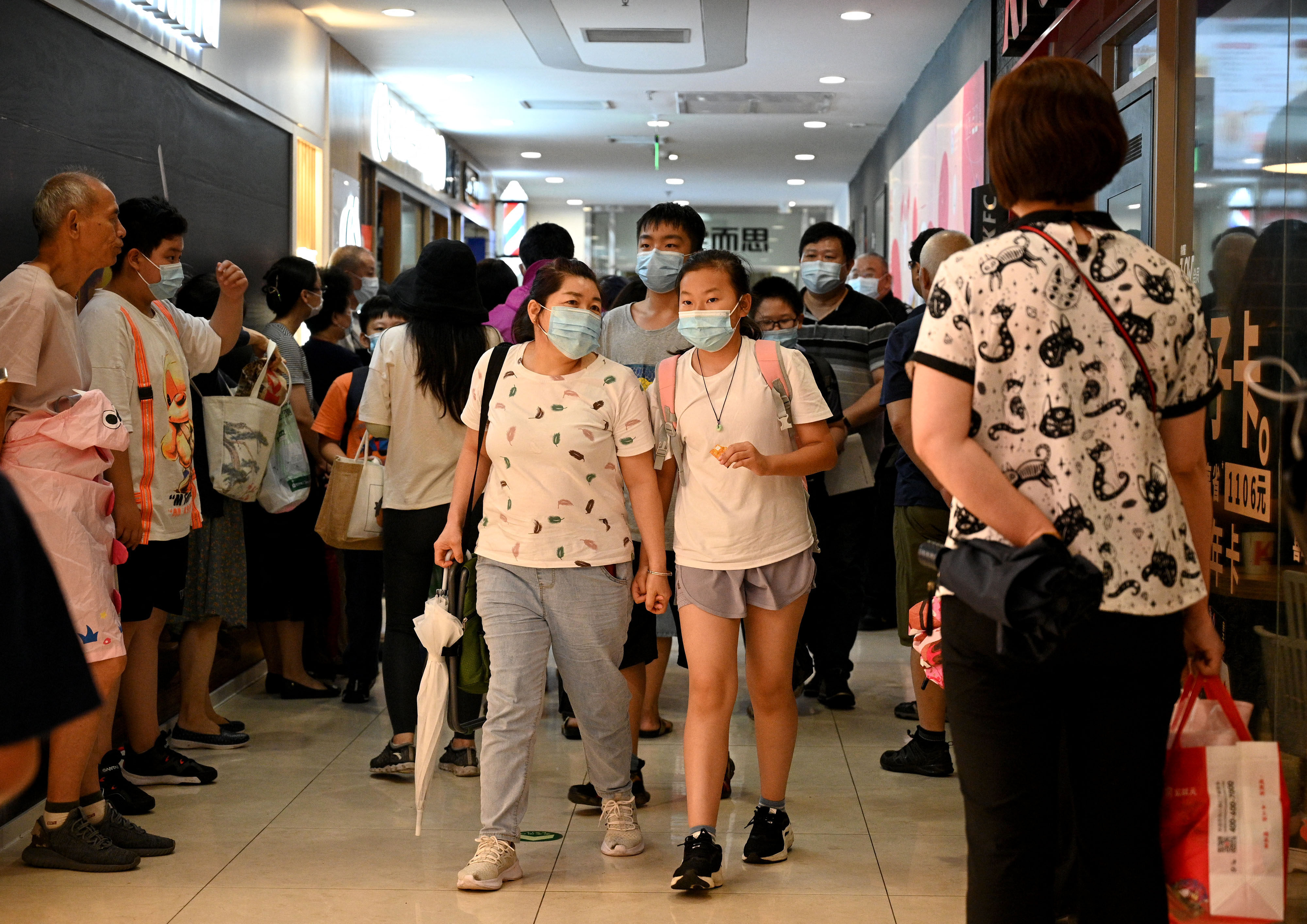 Students and parents come away from a tutoring centre in Beijing’s Haidian district on July 29. China’s crackdown on after-school tutoring has affected the market value of education companies. Photo: AFP