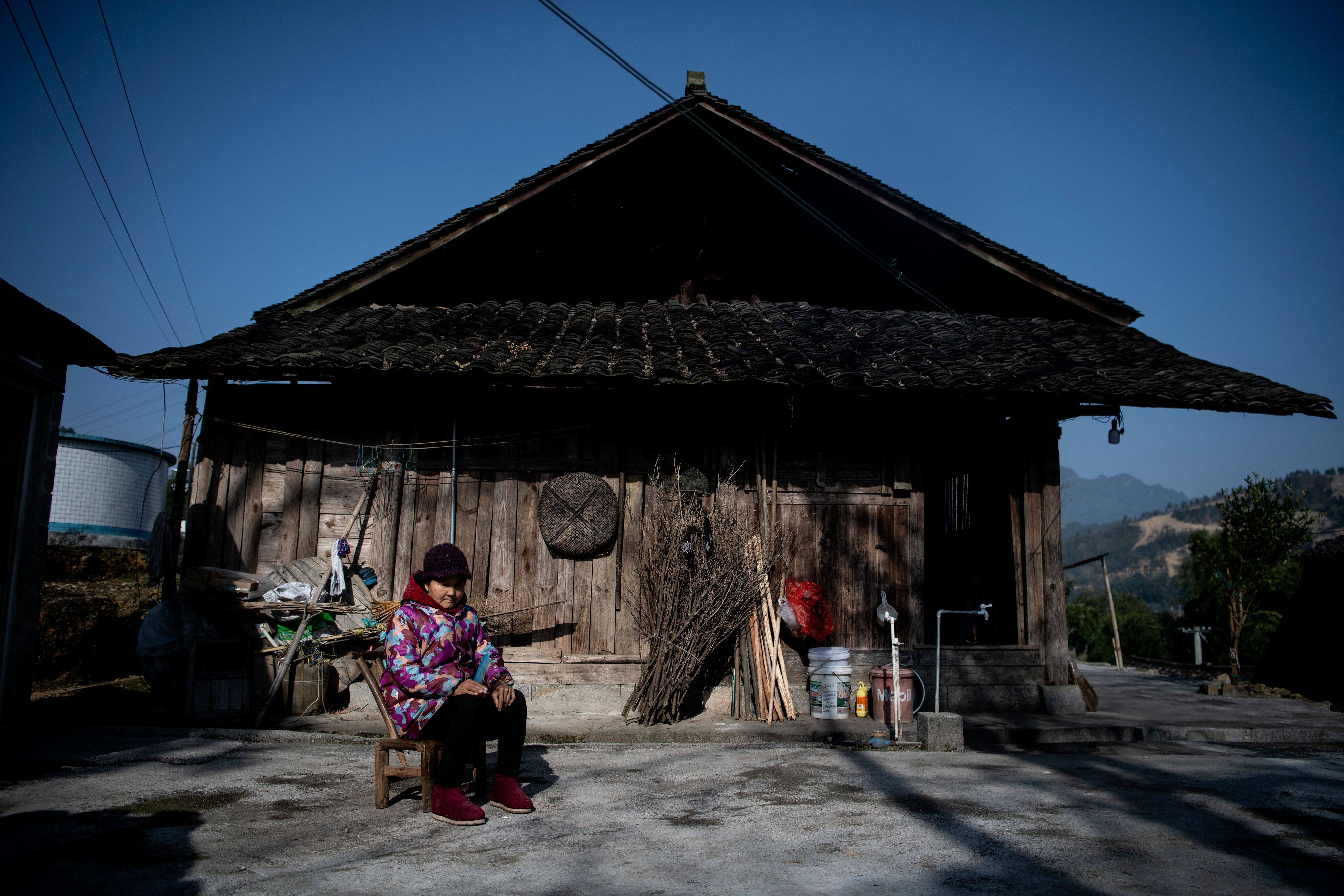 A woman sits in front of her residence in Baojing county, in central China’s Hunan province, on January 12. One per cent of China’s population currently owns 31 per cent of the nation’s wealth. Photo: AFP