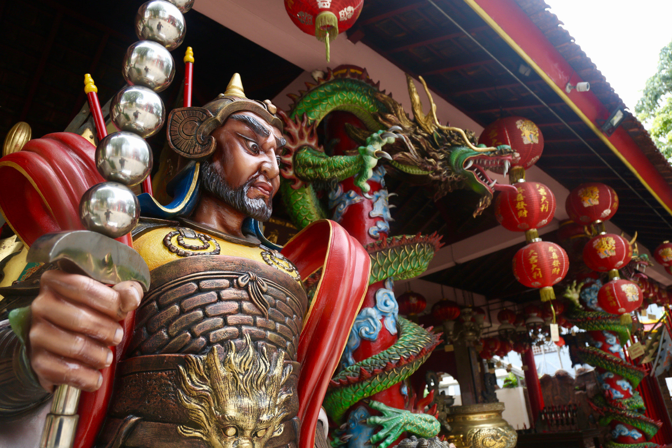 A warrior statue guards an altar at Vihara Dharmayana Kuta, Bali, Indonesia. Photo: Ian Neubauer