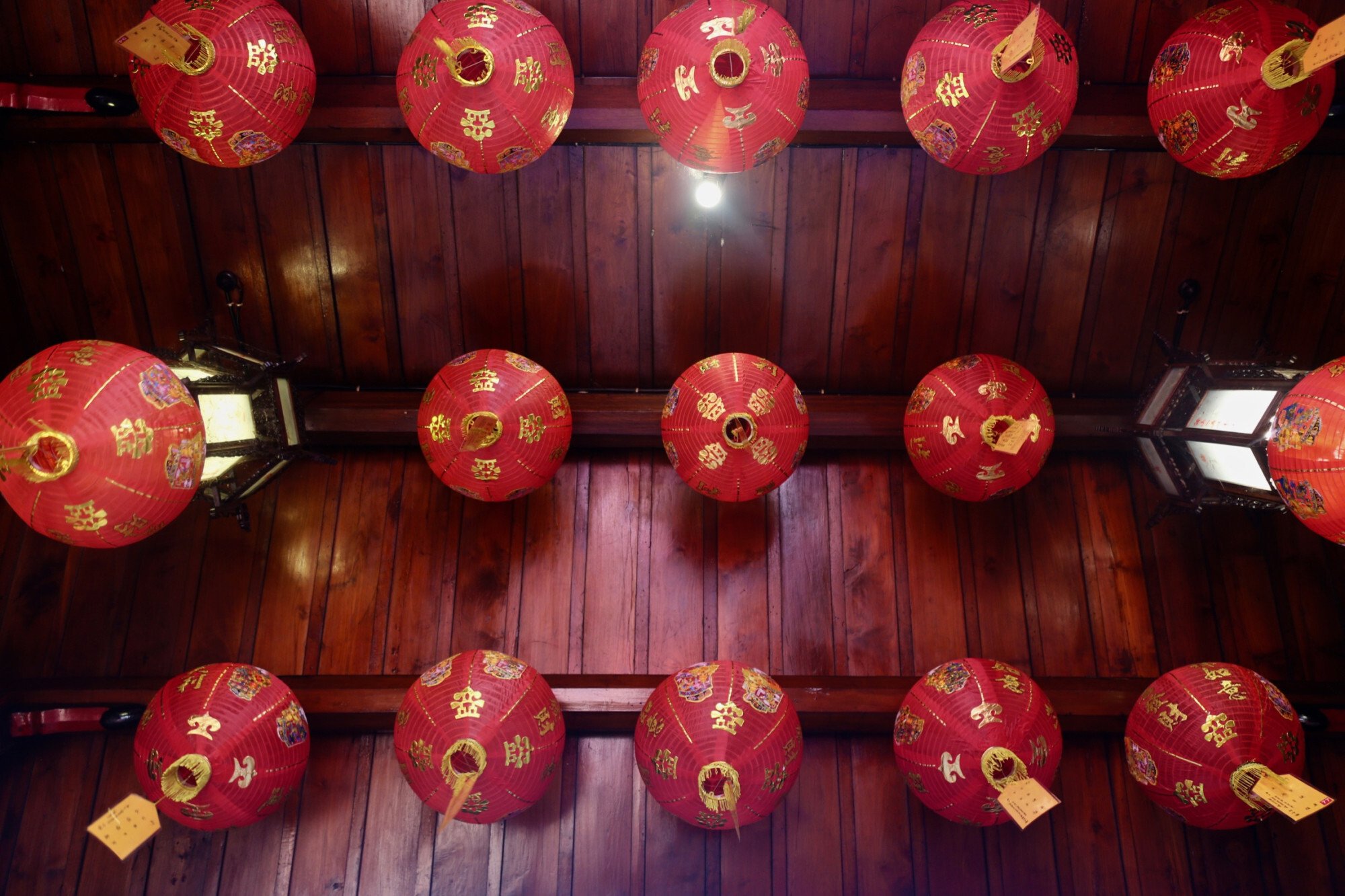 Red Chinese lanterns on the ceiling of a lotus pond at the front of Klenteng Ling Gwan Kiong. Photo: Ian Lloyd Neubauer