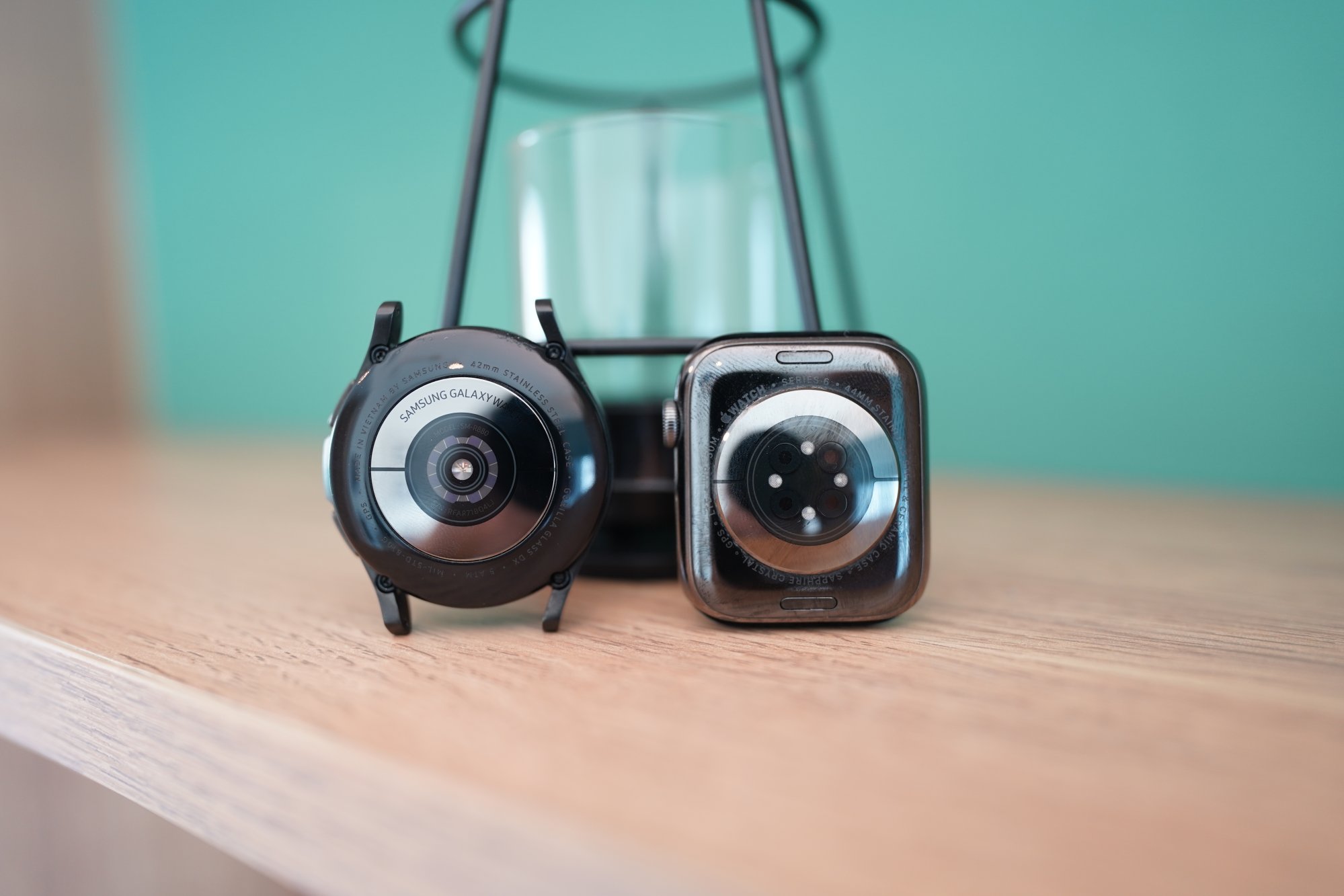 The Galaxy Watch 4 Classic (left) has a new all-in-one “BioActive” sensor that detect heart rate and perform bioelectrical impedance analysis. The back of the Apple Watch Series 6 has sensors to basically do the same thing. Photo: Ben Sin