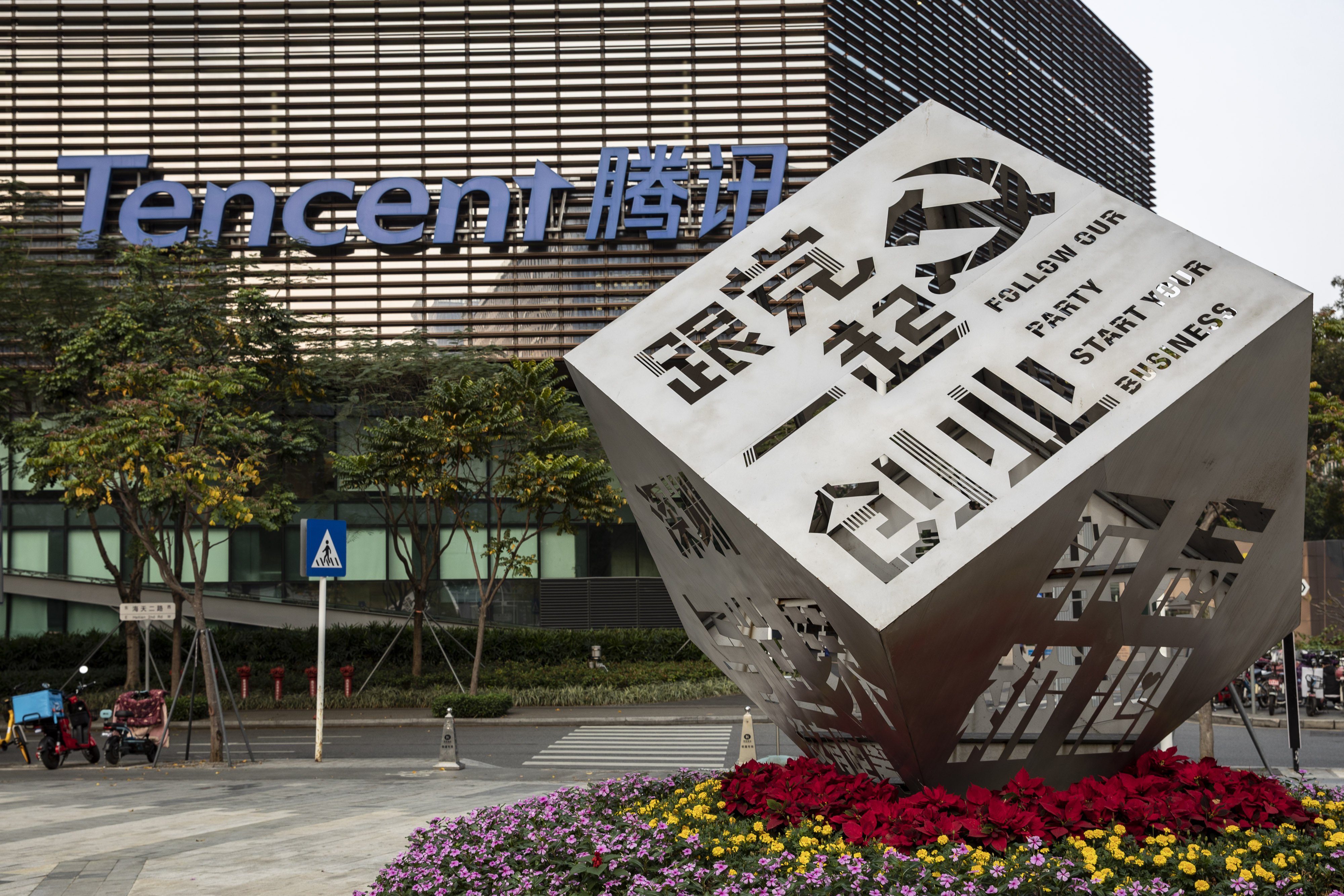 An installation saying “Follow our party, start your business” in front of Tencent Holdings headquarters in Shenzhen on March 20. Tech companies’ quick responses to new regulations show a willingness to adhere to a more disciplined financial model. Photo: Bloomberg