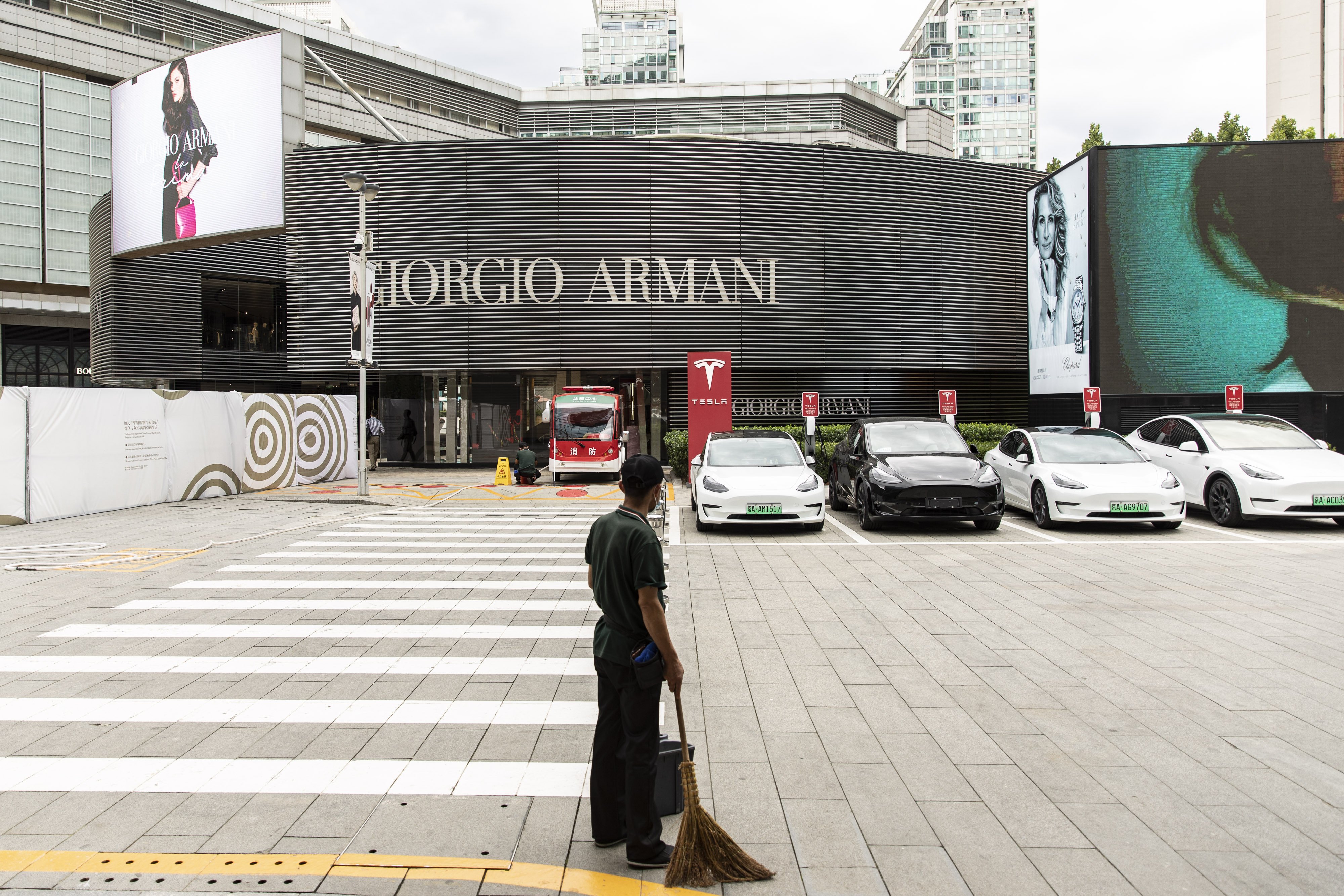 A cleaner stands outside an upscale retail area in Beijing, on August 25. As China continues to battle Covid-19 amid faltering growth, the promise of a fairer society could win popular support. Photo: Bloomberg