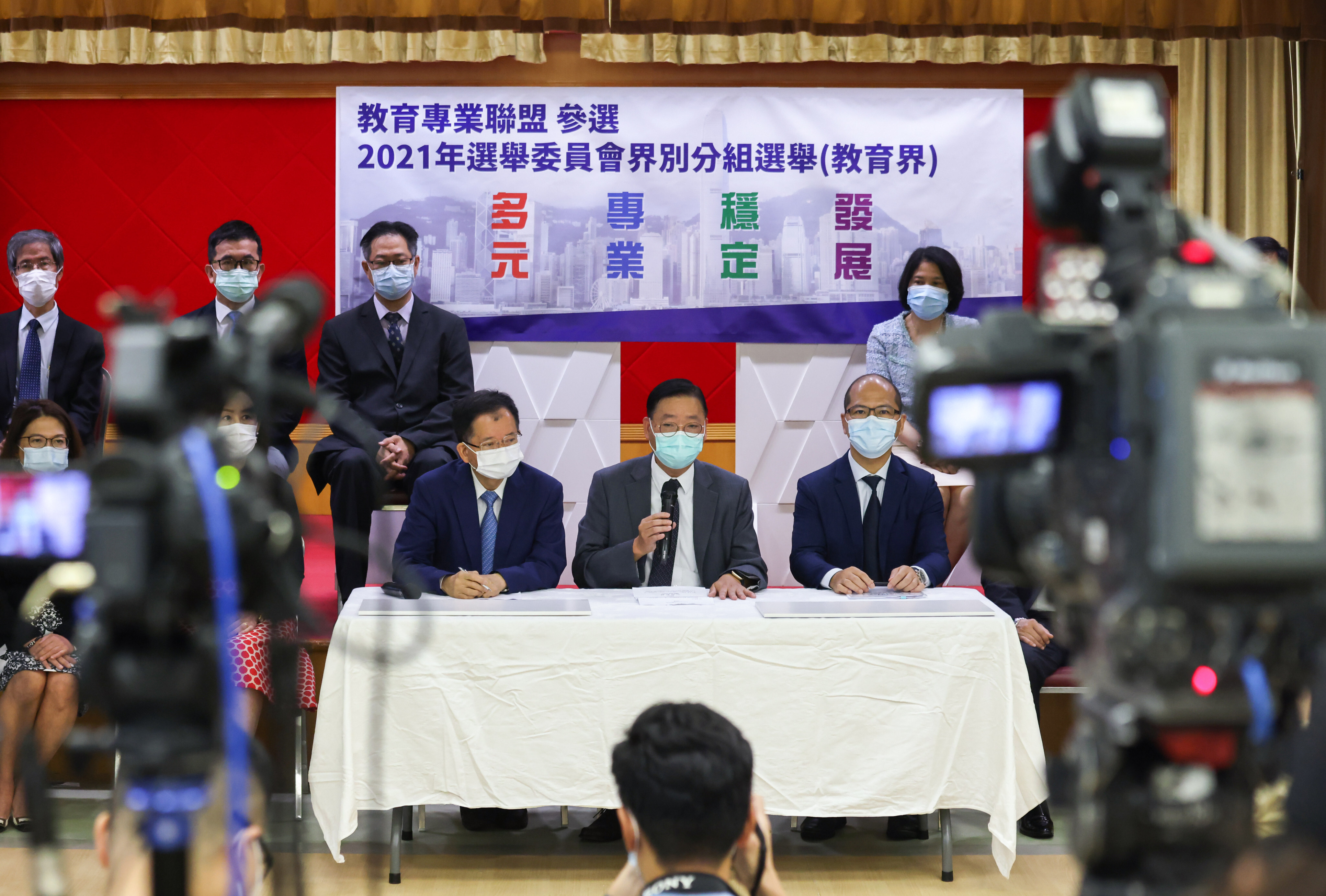 Thirteen educators, including (front, from the left) Ho Hon-kuen, Chiu Cheung-ki and Wong Kam-leung, hold a press conference at Causeway Bay Victoria Kindergarten & International Nursery on August 9 before they submit their applications to contest the Election Committee education subsector election. Photo: Nora Tam