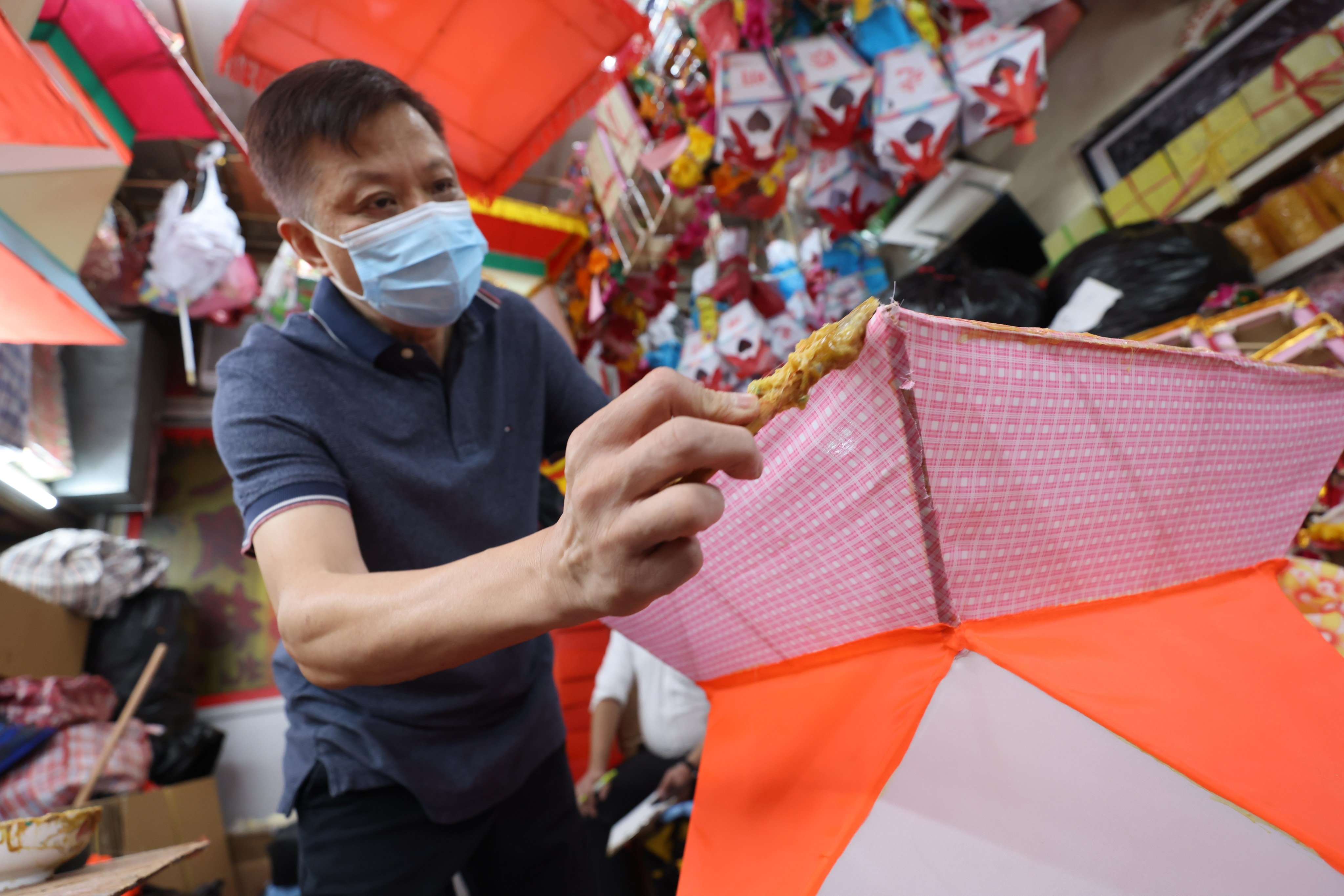 One of the last traditional Chinese lantern makers in Hong Kong, Ha Chung-kin works on an order at his shop in Sai Ying Pun. He thinks the local lantern-making industry will be dead within 40 years. Photo: Nora Tam