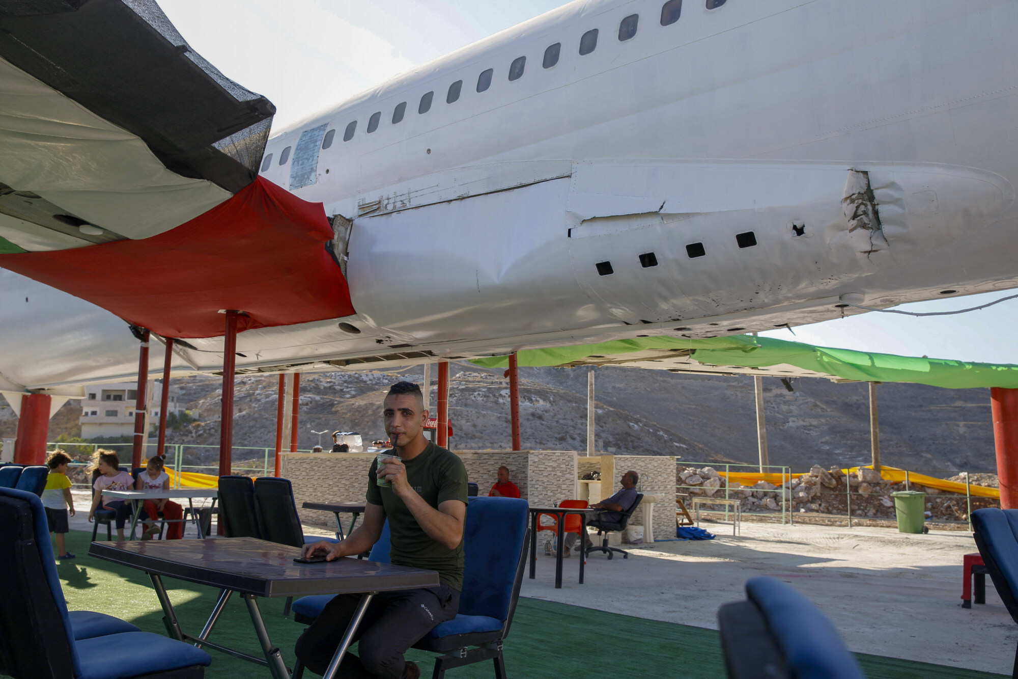 Twin brothers Khamis and Ata al-Sairafi opened The Palestinian-Jordanian Airline Restaurant and Coffee Shop in July, serving customers on the ground, but expect to welcome their first in-cabin diners soon. Photo: AP