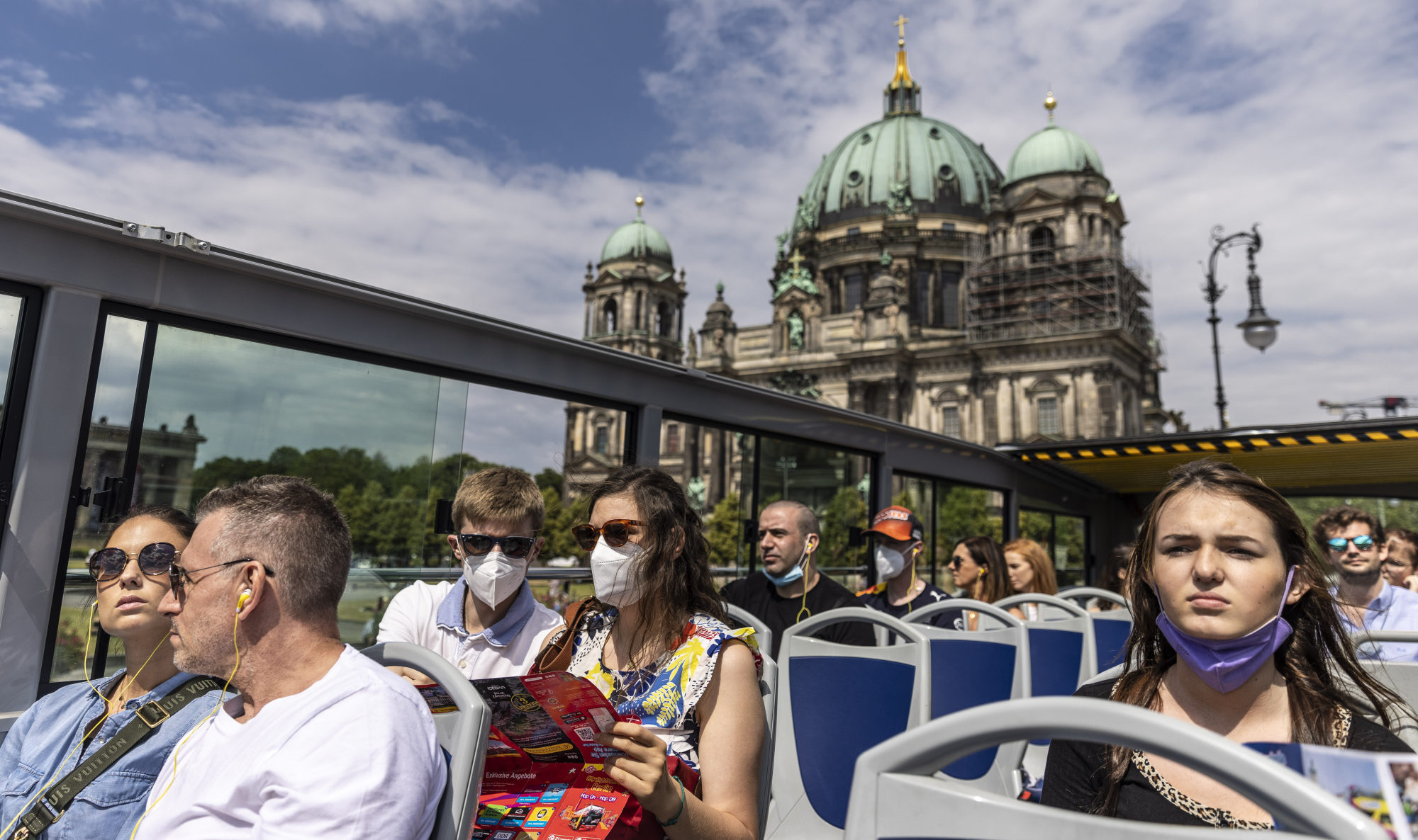 Passengers ride a double-decker tourist bus past the Berlin Cathedral. Photo: Getty Images