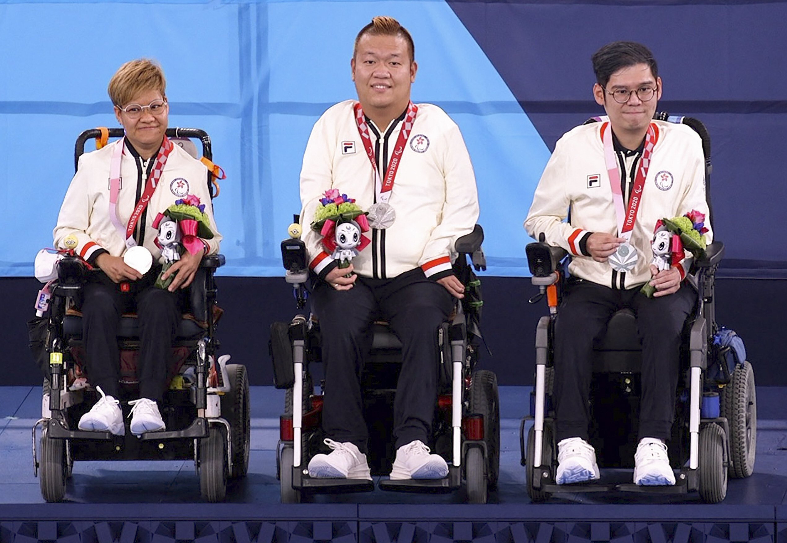 Hong Kong’s Vivian Lau Wai-yan, Leung Yuk-wing and reserve player Raymond Wong Kwan-hang celebrate on the podium after winning silver in the mixed pairs Boccia BC4 event at the Tokyo Paralympics earlier this month. Photo: HK Paralympic Committee