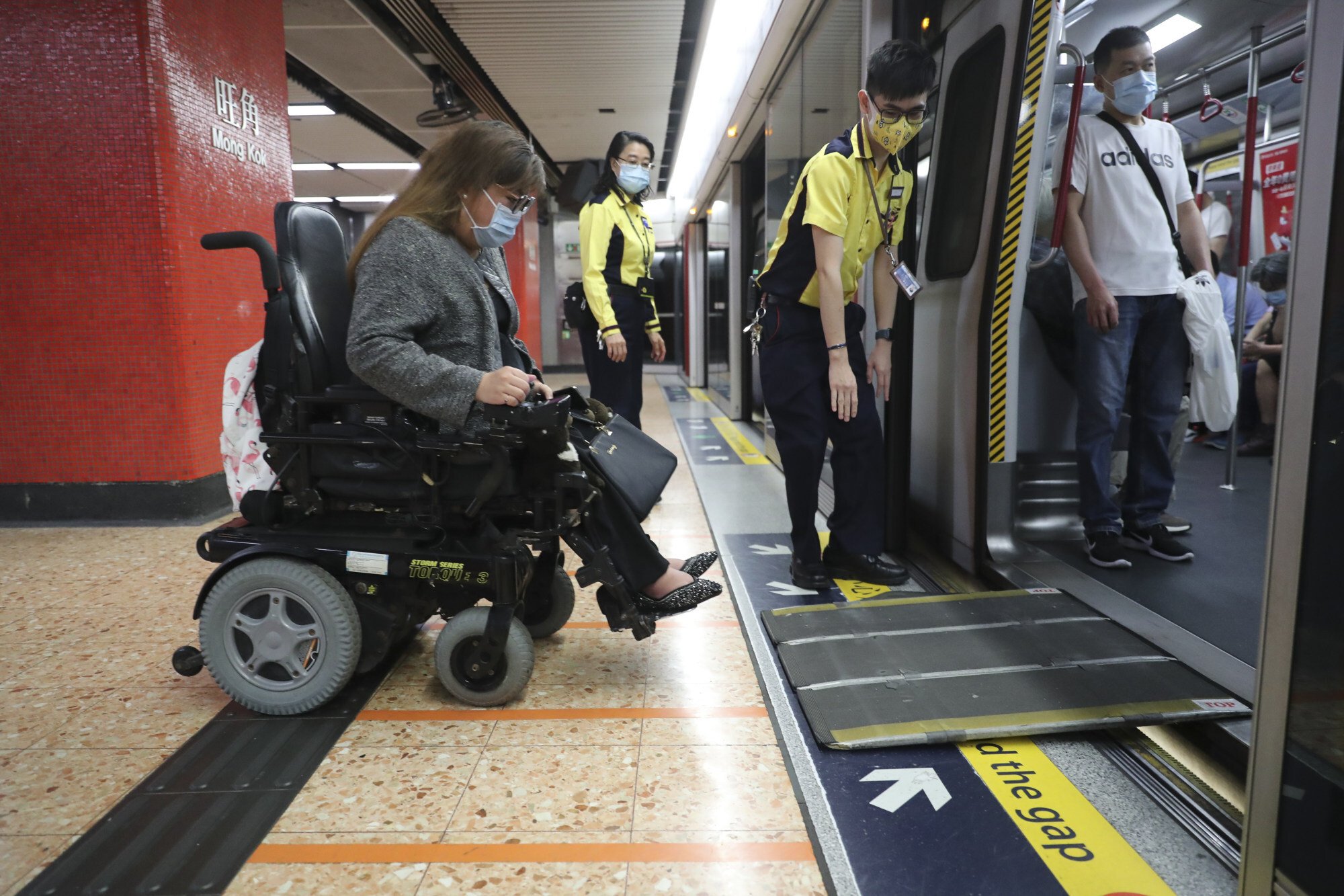 MTR staff set up a ramp for wheelchair user Carmen Yau on March 31. Photo: Edmond So