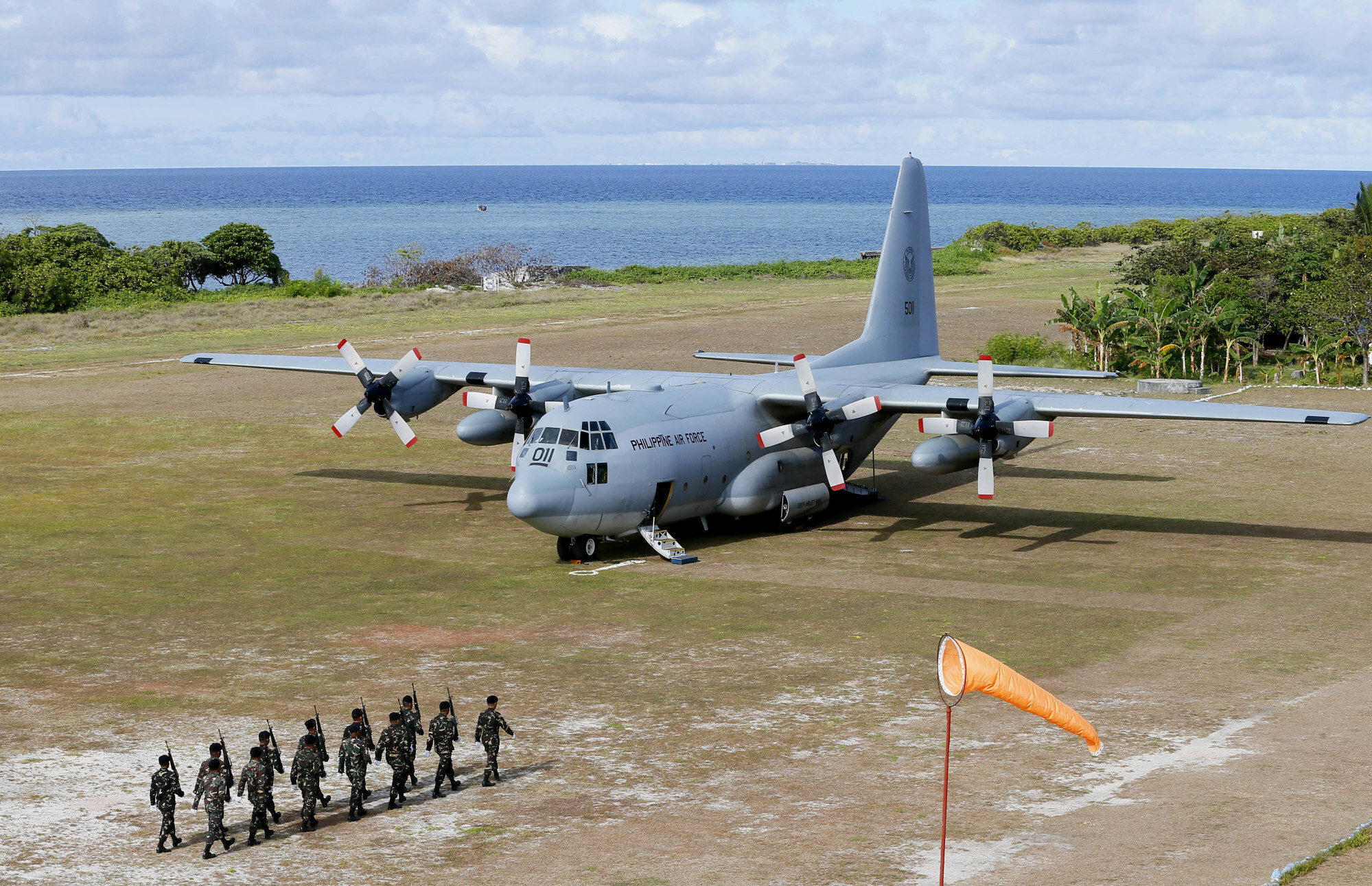 A Philippine Air Force C-130 transport plane and troops at the Philippine-claimed Thitu Island off the disputed Spratly chain of islands in the South China Sea. Photo: AP