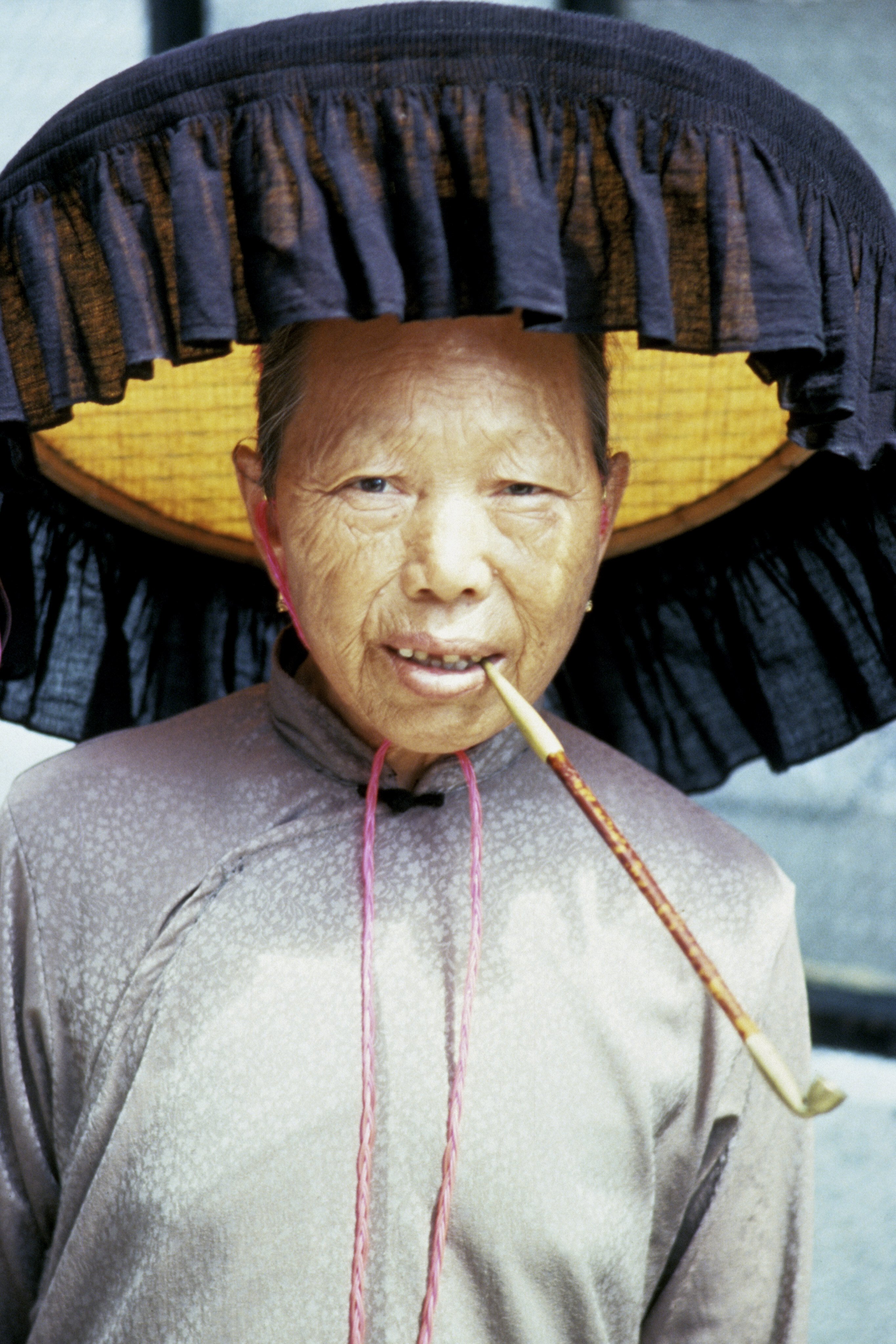 A woman wears a flat, fringed Hakka farmer’s hat. Practicality trumped fashion when it came to choosing hats in Hong Kong,  until the advent of the baseball cap, adopted to mimic Japanese who wore them to appear American. Photo: Getty Images