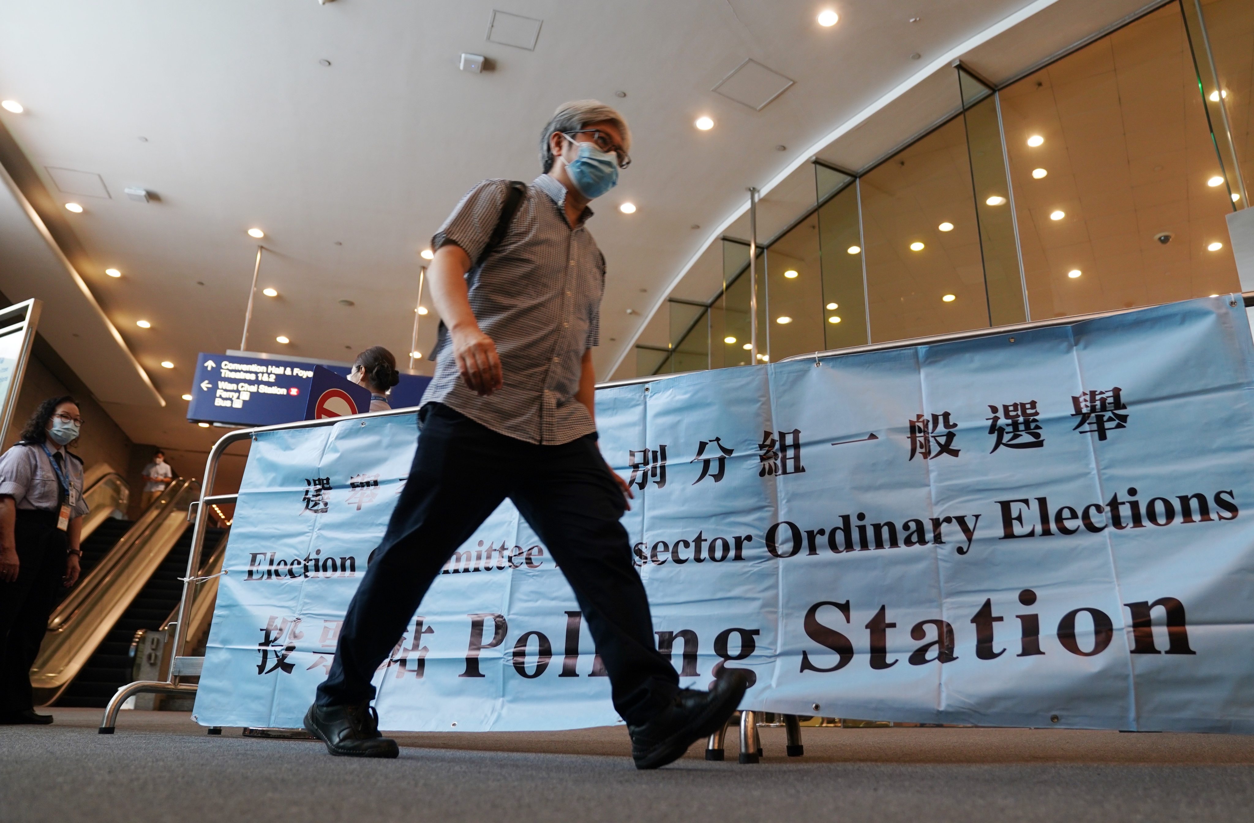 A citizen leaves after casting his ballot for the Election Committee polls, at the Hong Kong Convention and Exhibition Centre, in Wan Chai, on September 19. The turnout of about 90 per cent for the election, the first to be held after electoral reforms this year, signals voter confidence in the system. Photo: Xinhua