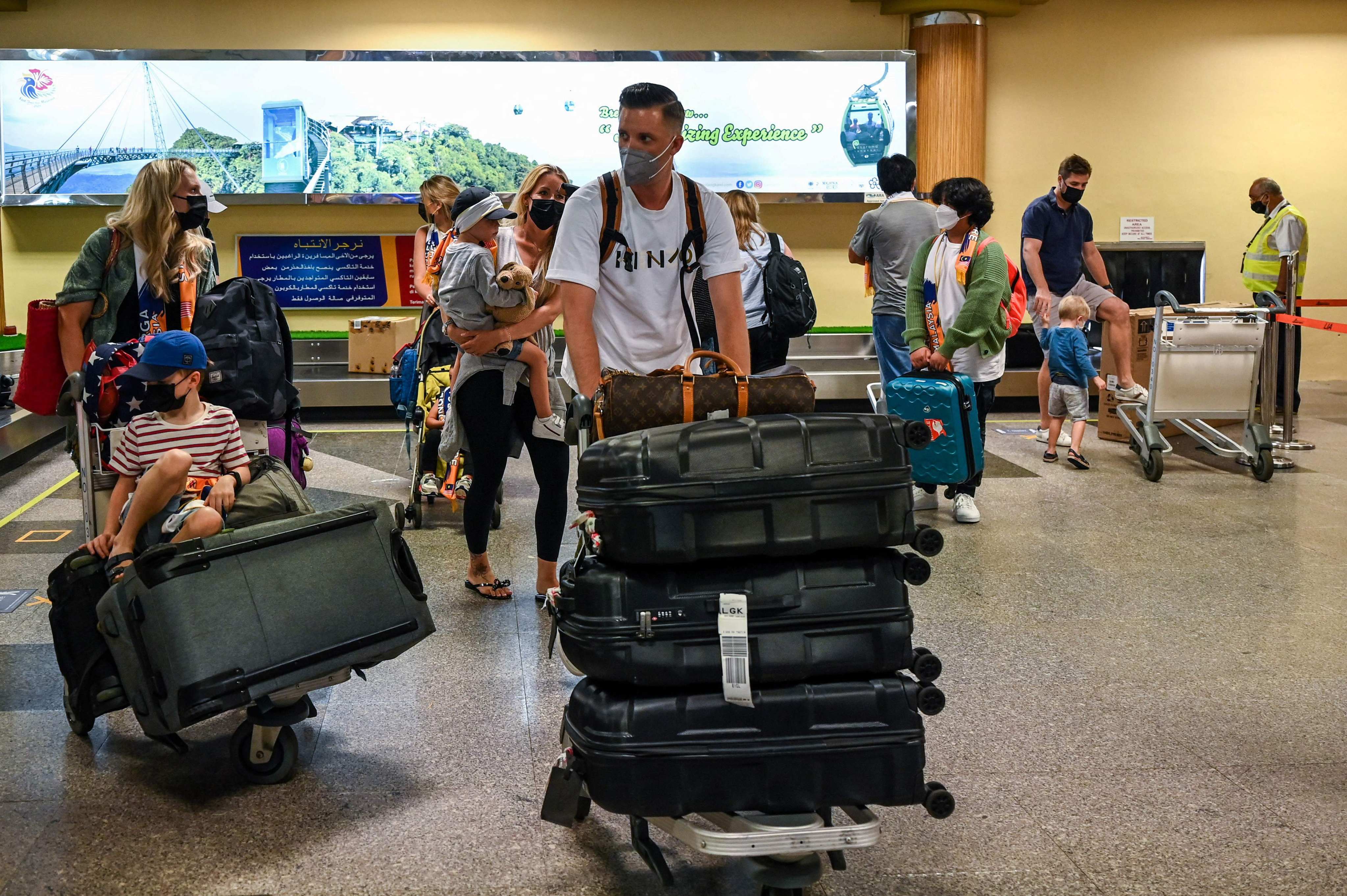 Passengers collect their luggage after landing in Langkawi from Kuala Lumpur International Airport on September 16, 2021, as the holiday island reopened to domestic tourists following closures due to restrictions to halt the spread of the Covid-19 coronavirus. Photo: AFP