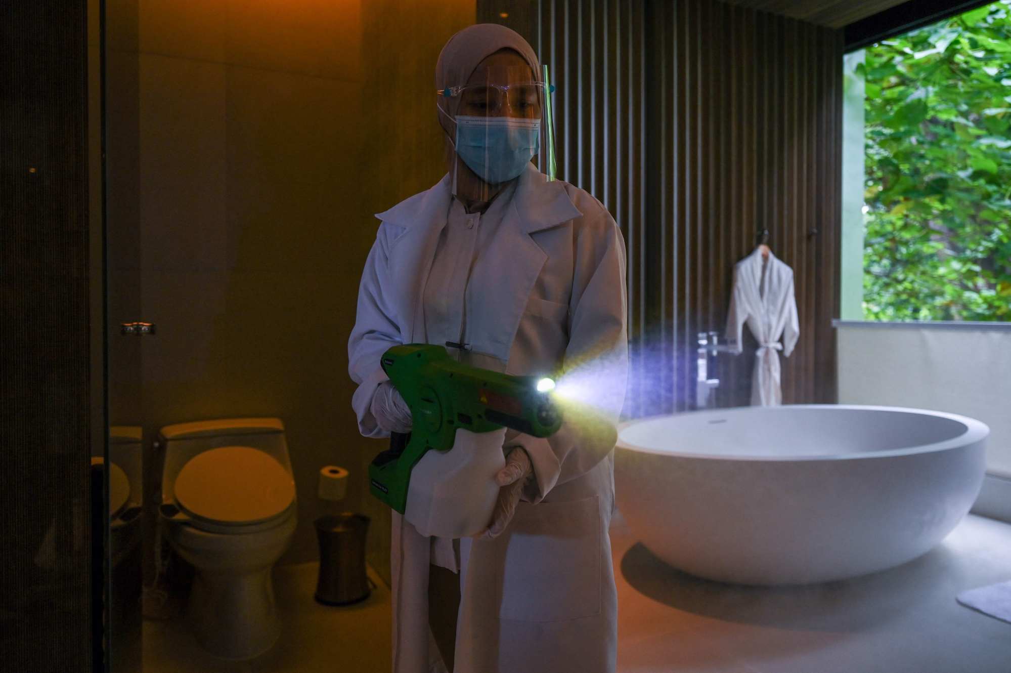 A housekeeping worker sanitises a bathroom at the Ritz-Carlton hotel, in Langkawi. Photo: AFP
