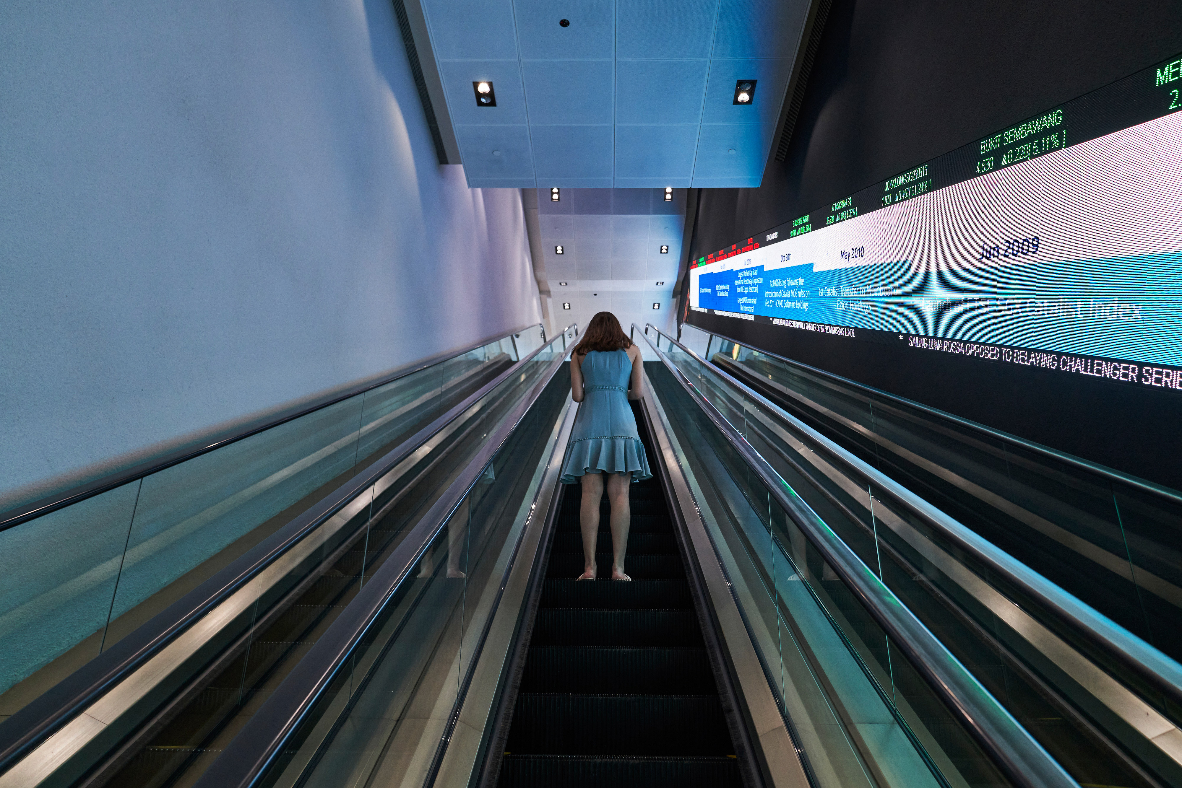 A woman uses the escalator at the Singapore Exchange headquarters on February 17. The exchange is the first major bourse in Asia to welcome listings of special purpose acquisition companies. Photo: Bloomberg
