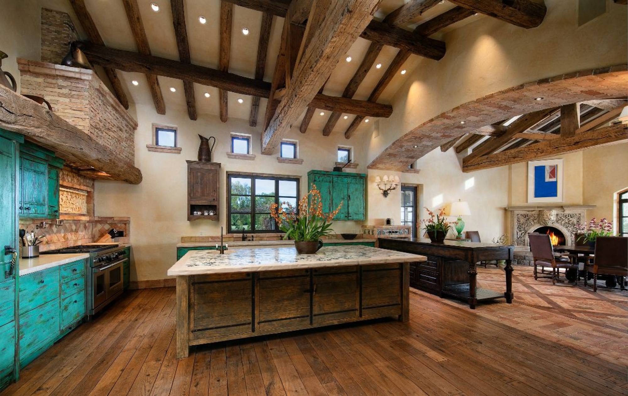 Ocean View’s kitchen features exposed natural beams and an adjacent dining room and fireplace. Photo: Jim Bartsch