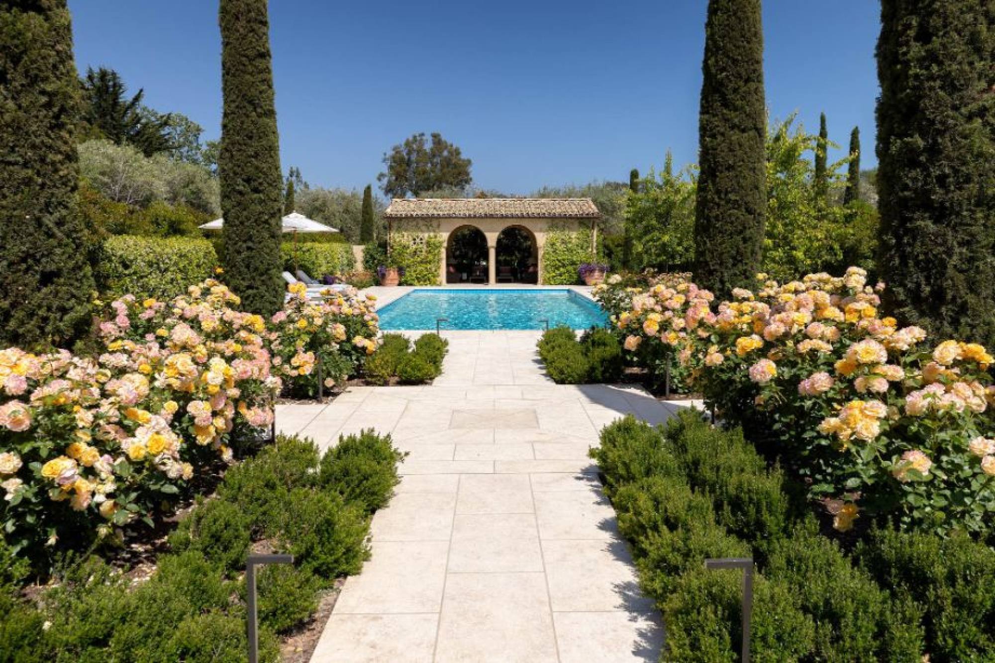 Bellevue’s Italian style pool is lined with roses. Photo: Jim Bartsch
