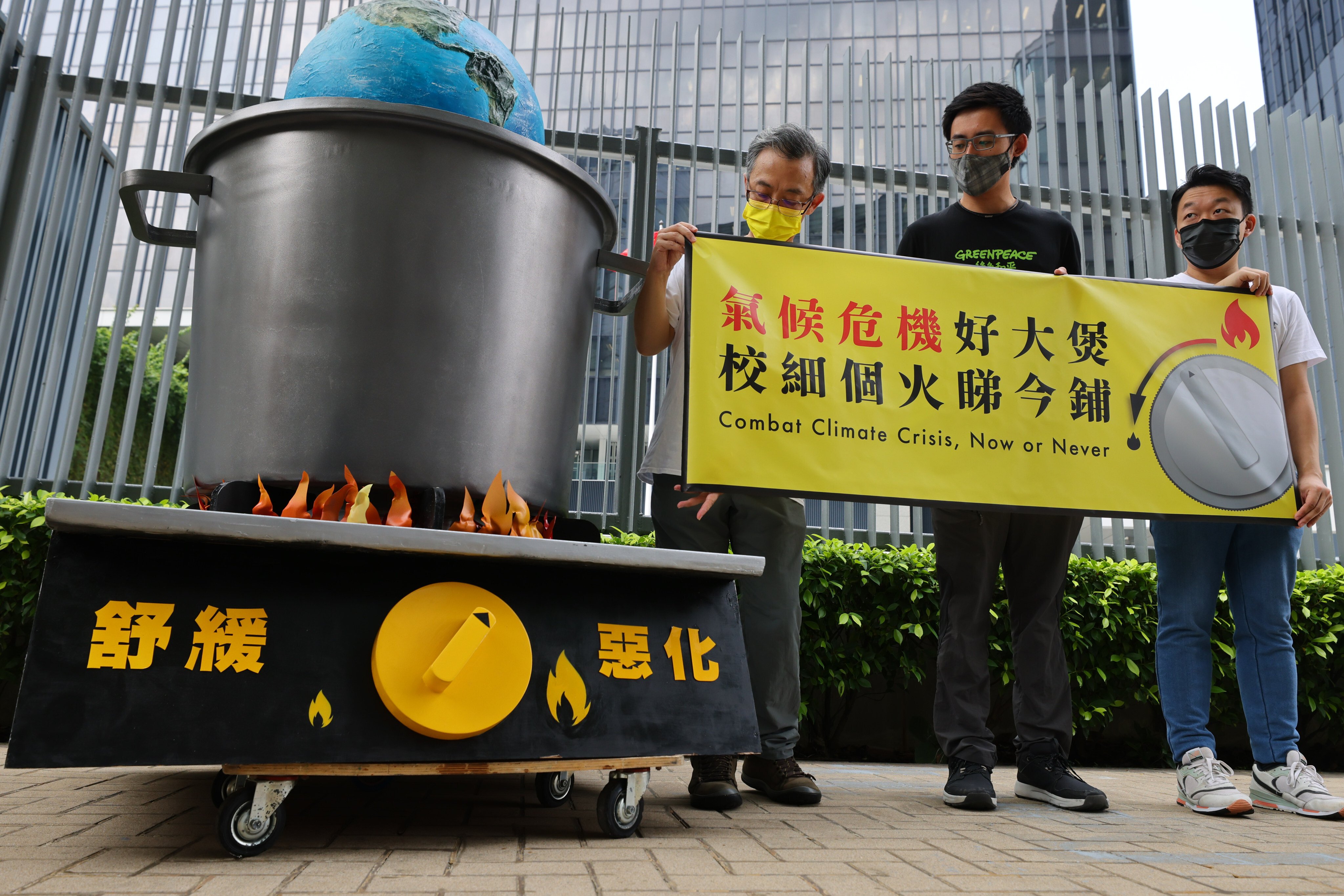 Environmental activists (left to right) Ringo Mak, Ng Hon-lam and Thierry Leung gather outside the government headquarters in Admiralty on September 28 to appeal to the Environment Bureau to act on climate change. Photo: Dickson Lee