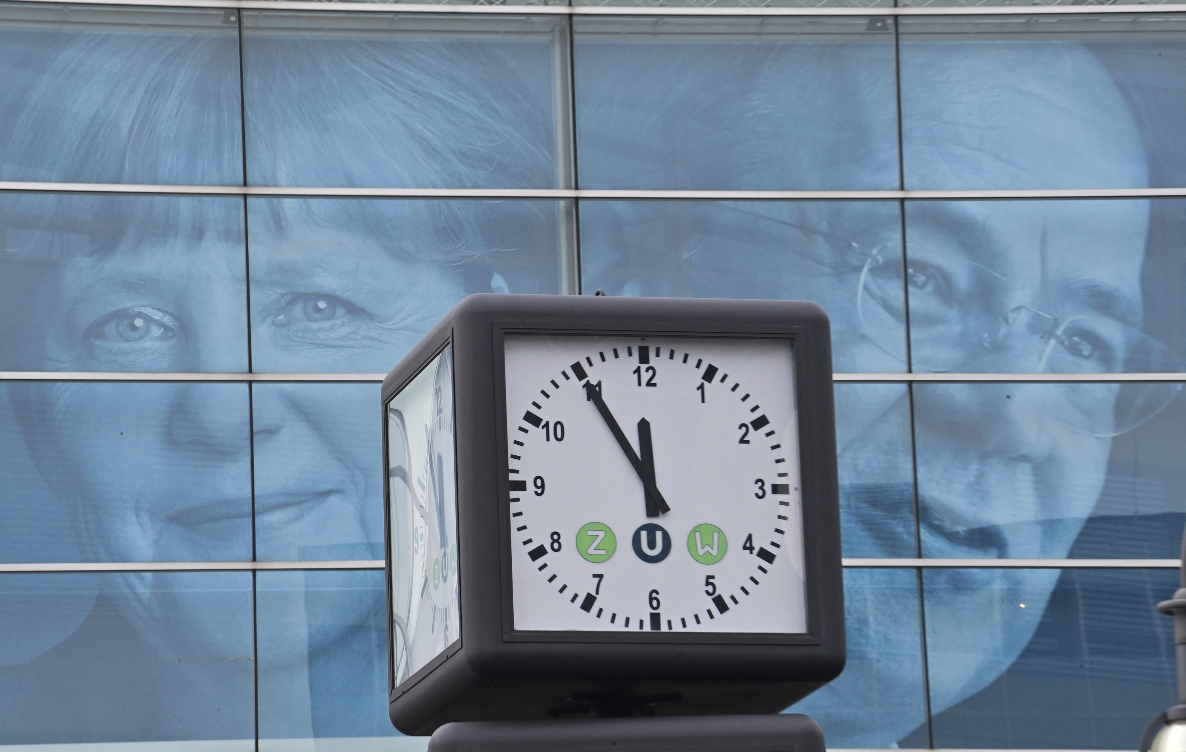 A clock displays the time in front of posters of German Chancellor Angela Merkel and Armin Laschet in Berlin on September 27. German voters called time on Merkel’s centre-right Christian Democratic Union last month, part of a global leftward shift amid an uneven recovery from the pandemic. Photo: DPA