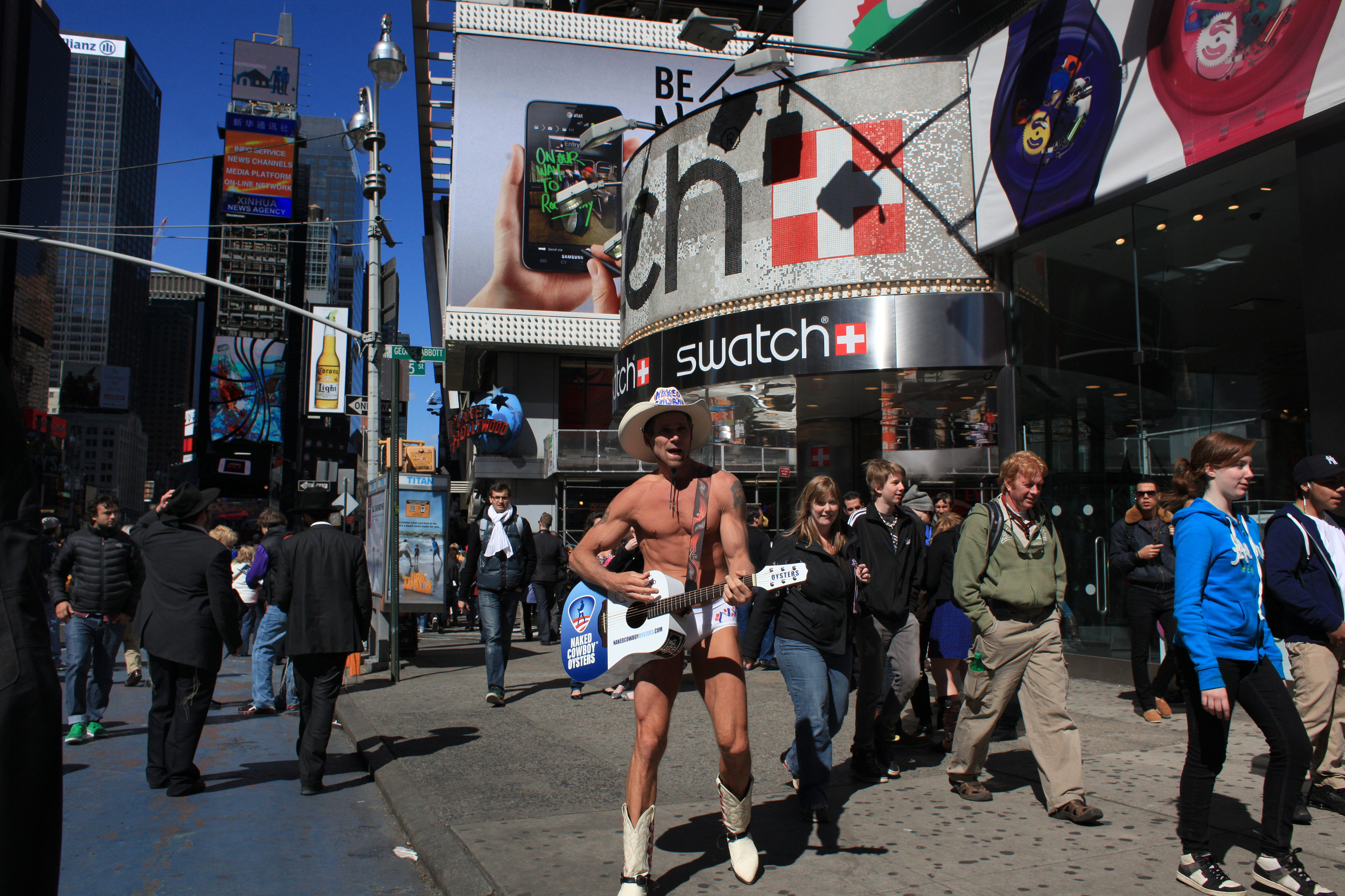 The Naked Cowboy performing in Time Square, New York. Times Square is the major commercial intersection in Midtown Manhattan, New York City. Time Square, New York, USA. 27th April 2012. Photo Tim Clayton (Photo by Tim Clayton/Corbis via Getty Images)
