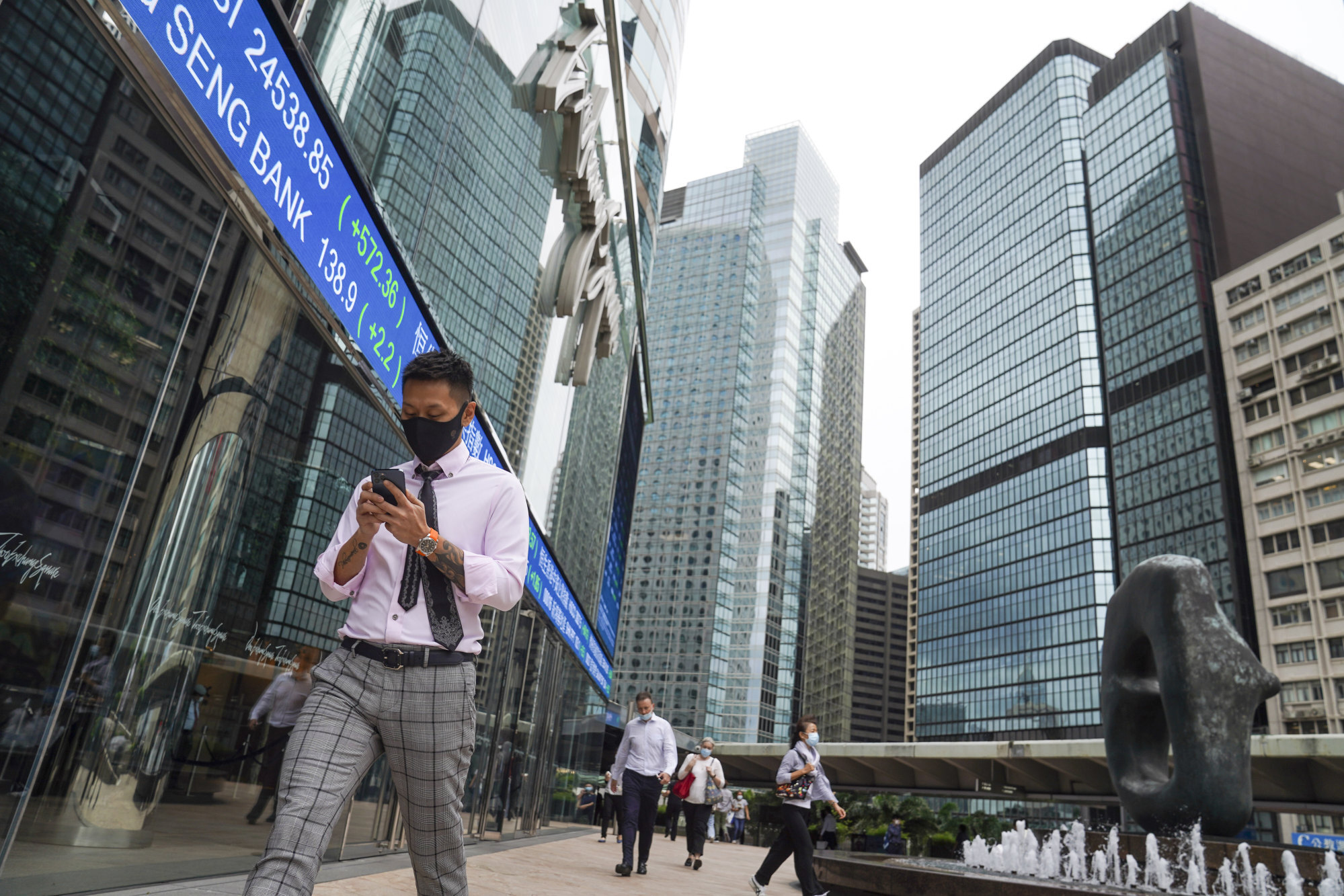 Office workers walk past the Exchange Square complex in Central. Photo: SCMP / Sam Tsang