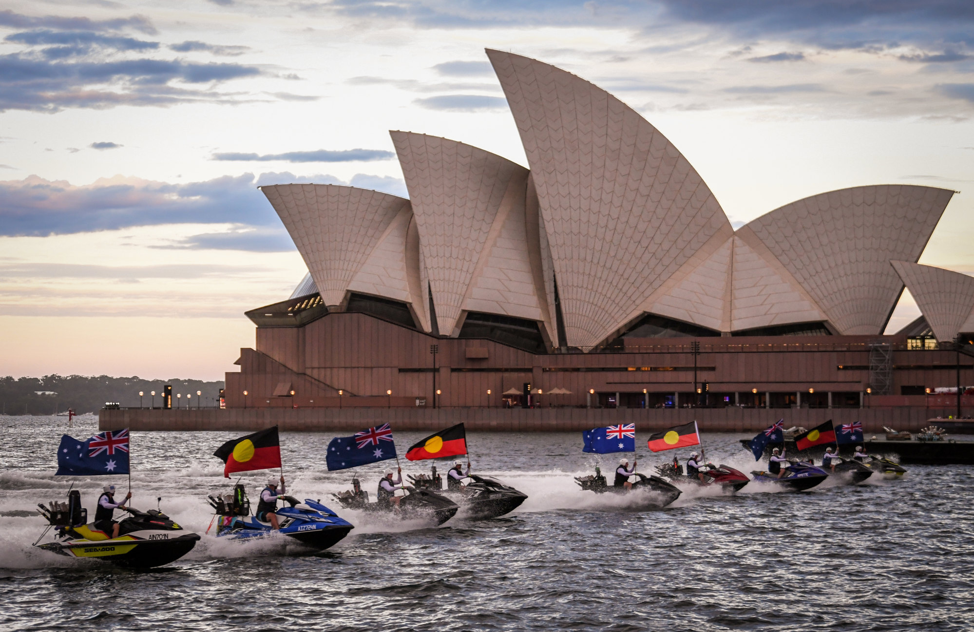 Jet skis displaying Australian and Aboriginal flags in front of the Sydney Opera House during an Australia Day show on January 26 this year. Photo: Getty Images