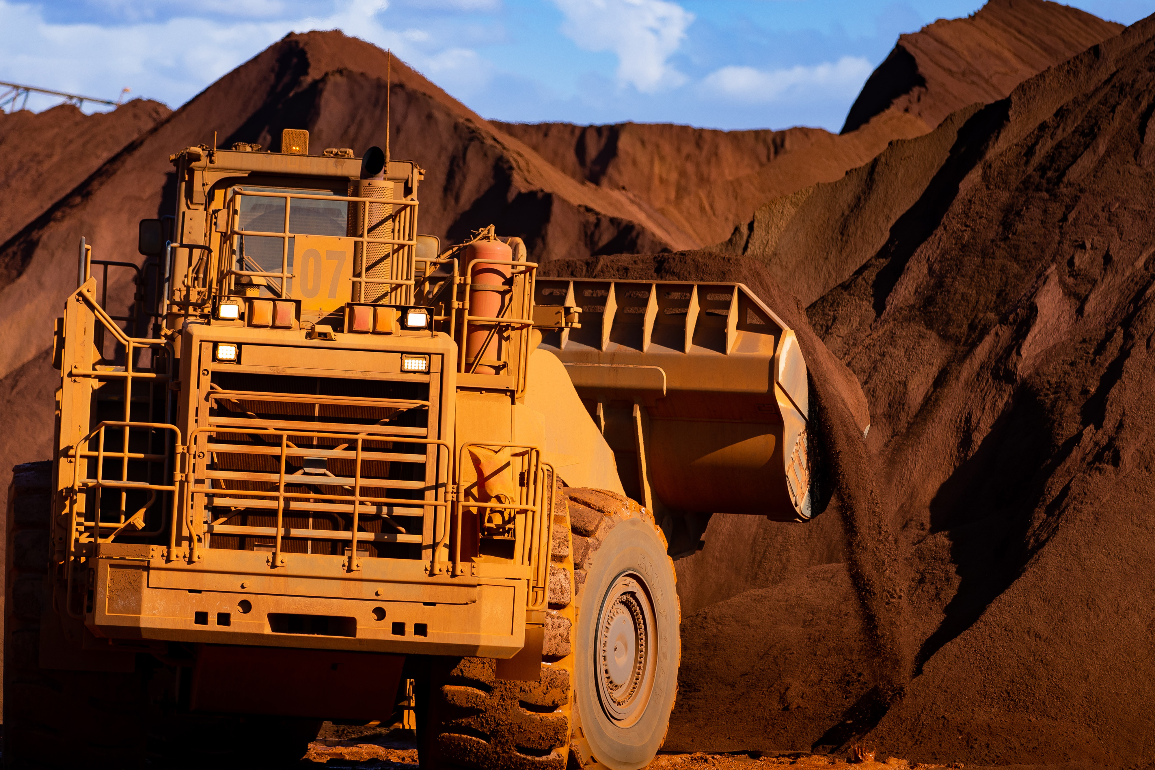 Excavators move iron ore at Port Hedland, Australia. File photo: Bloomberg