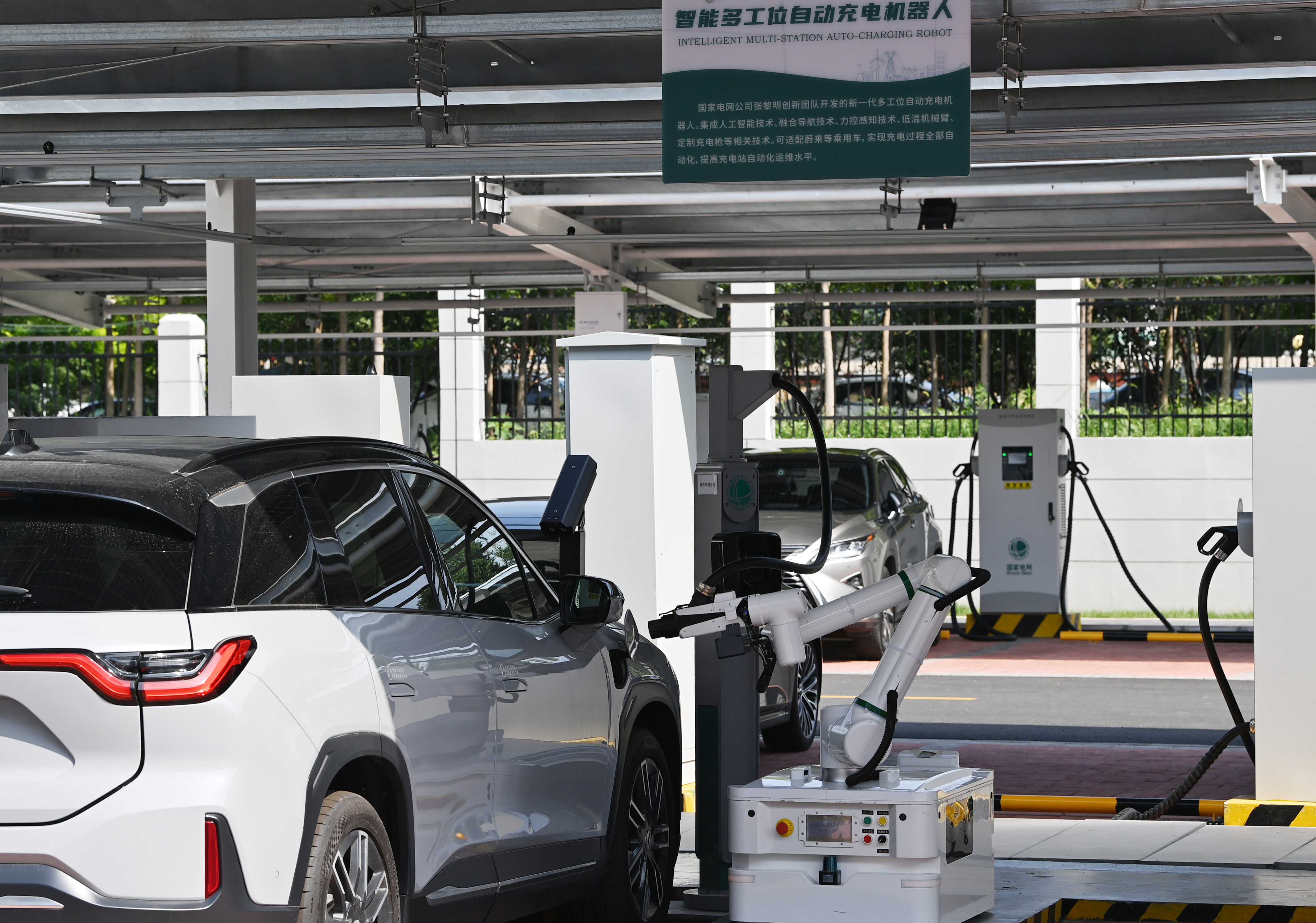 A charging robot for electric cars operates at the Jinmenhu New Energy Vehicle Integrated Service Centre in Tianjin on August 18. Chinese-made electric vehicles are poised to swamp international markets. Photo: Xinhua