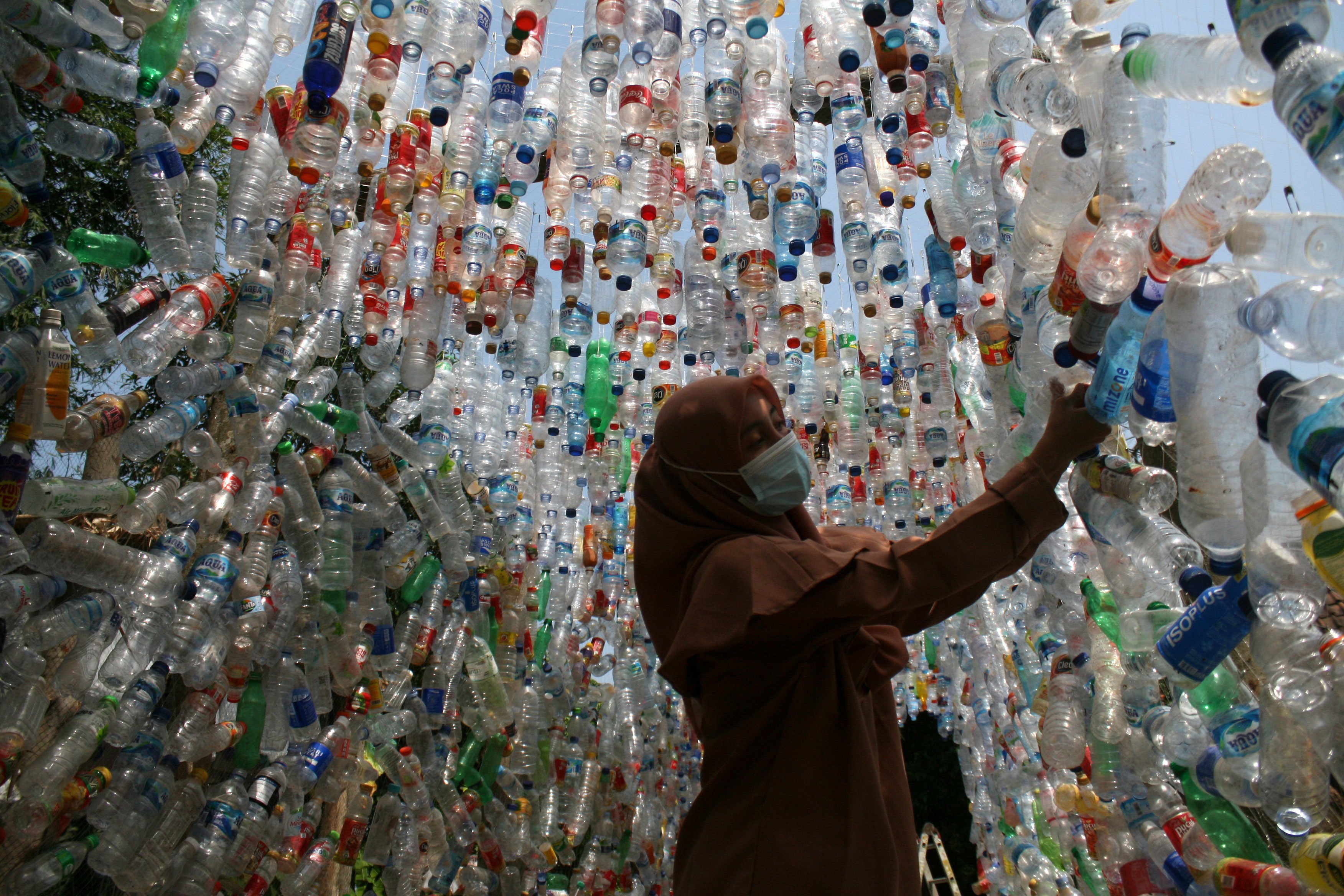 A woman looks at an installation set up with plastic bottles during an environmental campaign in Gresik, East Java, Indonesia, on September 9. It was made from plastic collected from rivers in Gresik and Surabaya. Photo: Xinhua