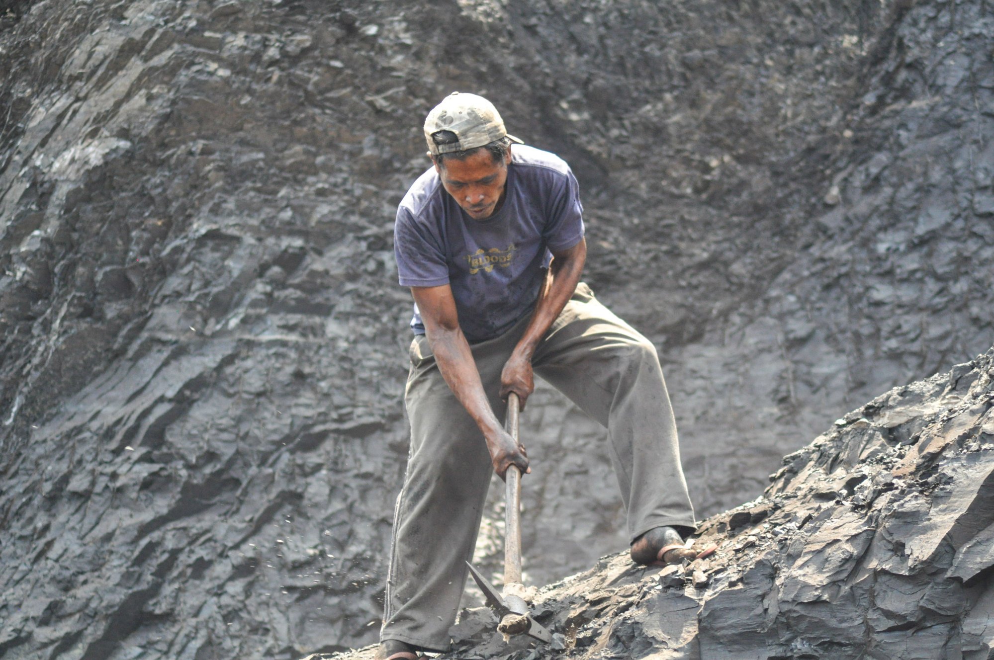 The community mine at Darmo is one of around 200 such mines in the area which operate without permits and are run by local residents. Photo: Hafidz Trijatnika