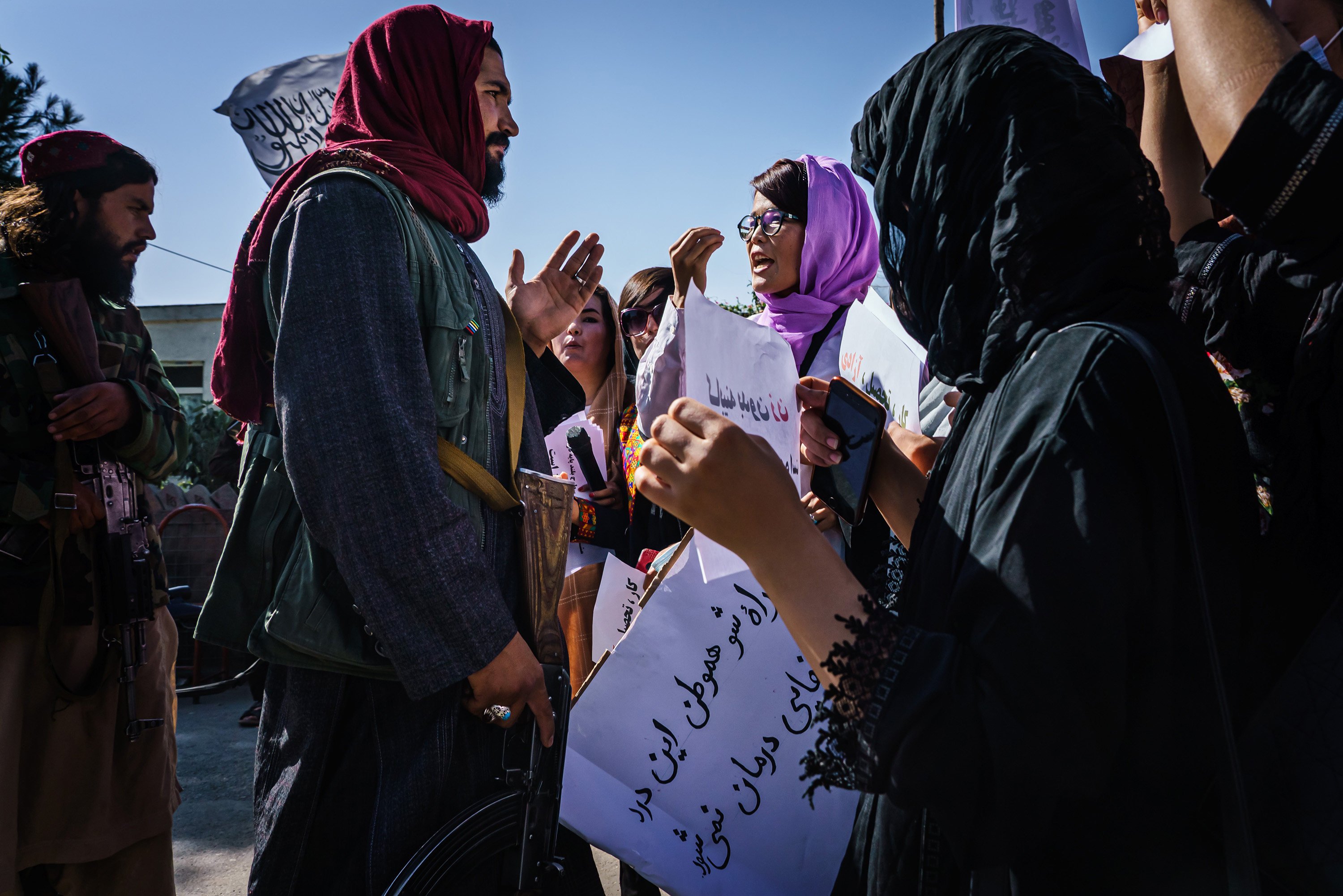 Taliban fighters try to stop protesters marching through the Dashti-E-Barchi neighbourhood, a day after the Taliban announced an all-male interim government with no representation for women and ethnic minority groups, in Kabul, Afghanistan. Photo: TNS