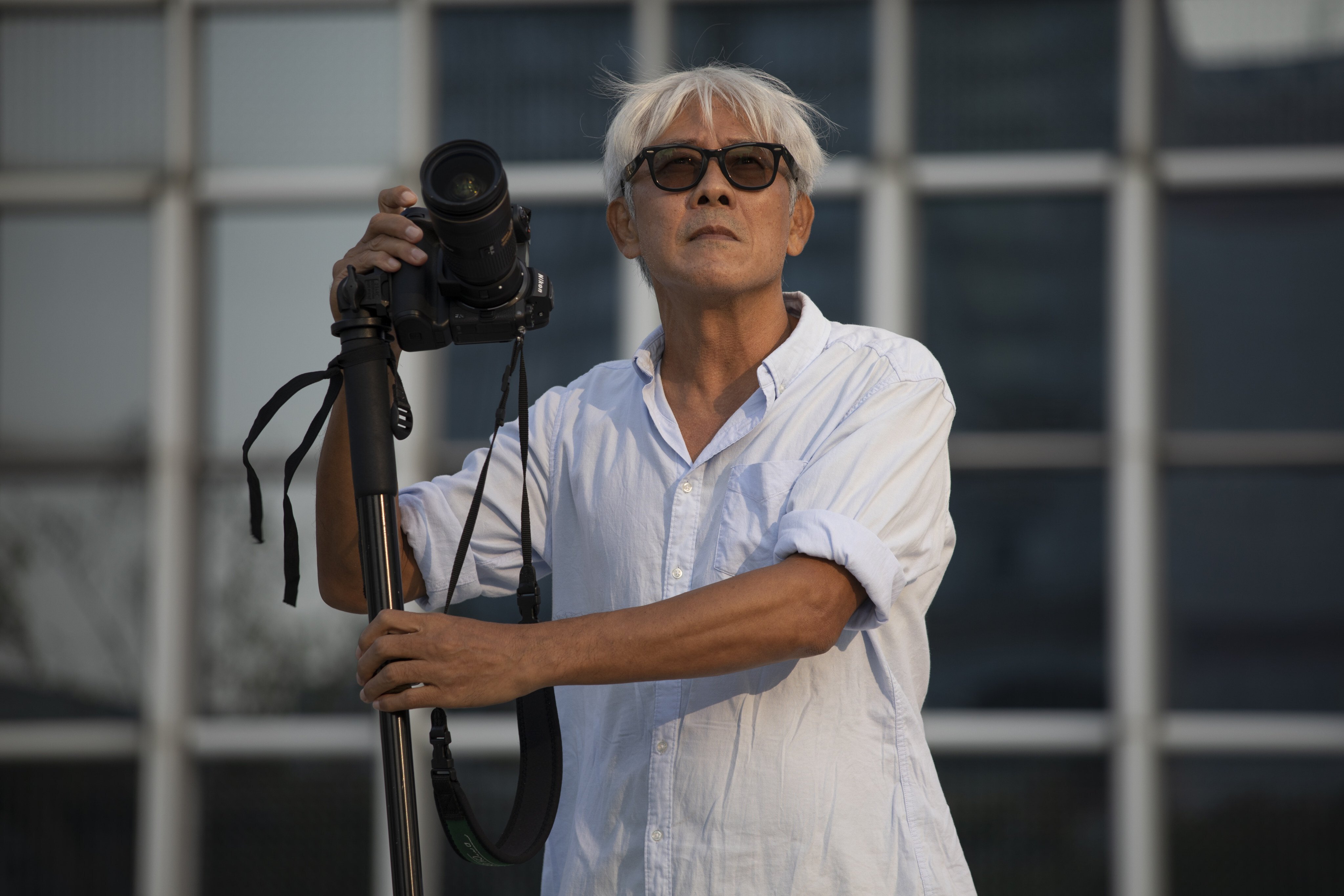 Hong Kong photographer John Fung at the IFC in Central, Hong Kong. He says living in the present is what informs his art. Photo: Antony Dickson