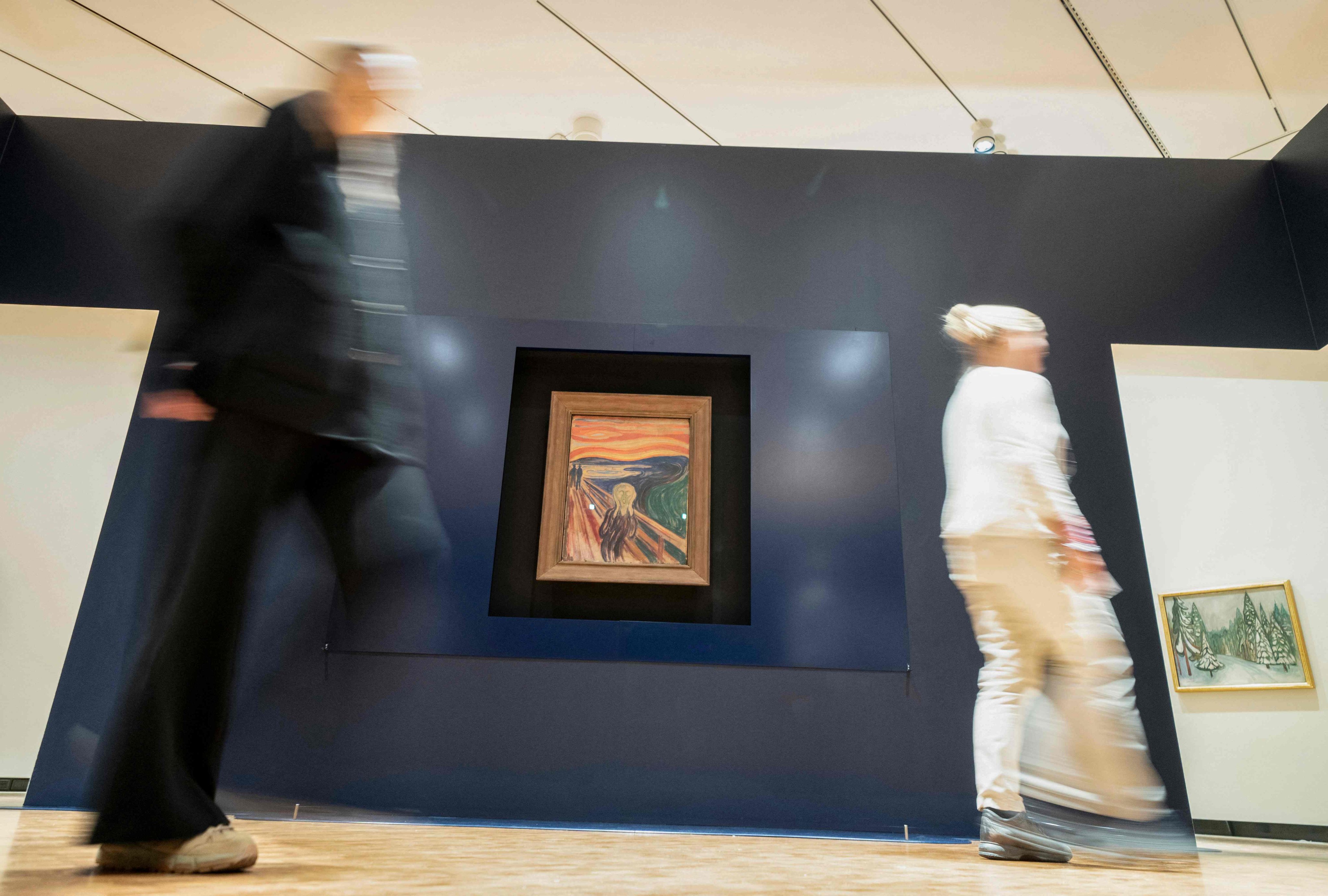 People pass by the painting “The Scream” by Norwegian artist Edvard Munch in the new Munch Museum in Oslo. Three versions of the  famous work are on show. Photo: Terje Pedersen/NTB/AFP
