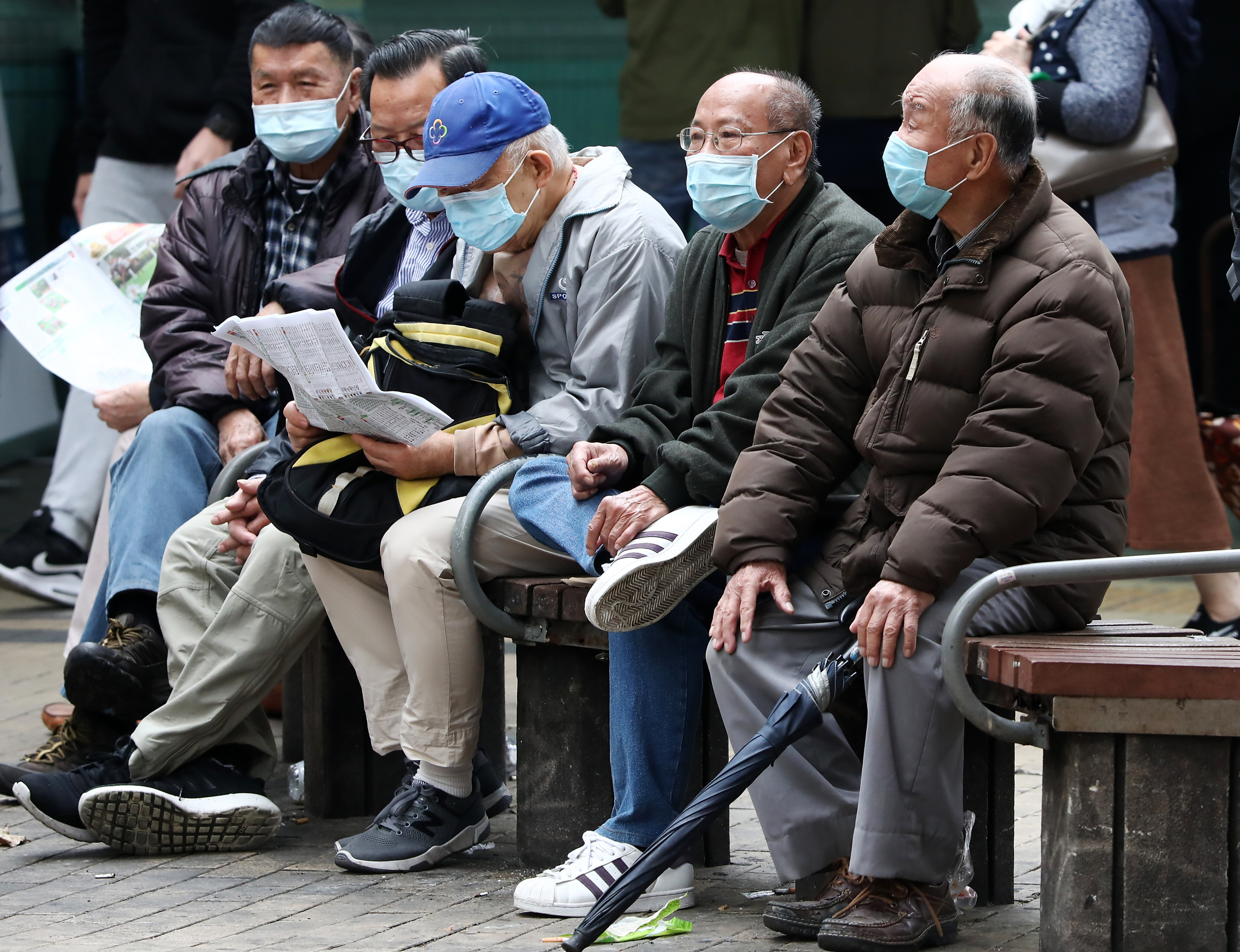 Elderly men sit on a bench in Sham Shui Po on December 23, 2020.  Surveys show the biggest concern for people in retirement is outliving their savings. Photo: Jonathan Wong