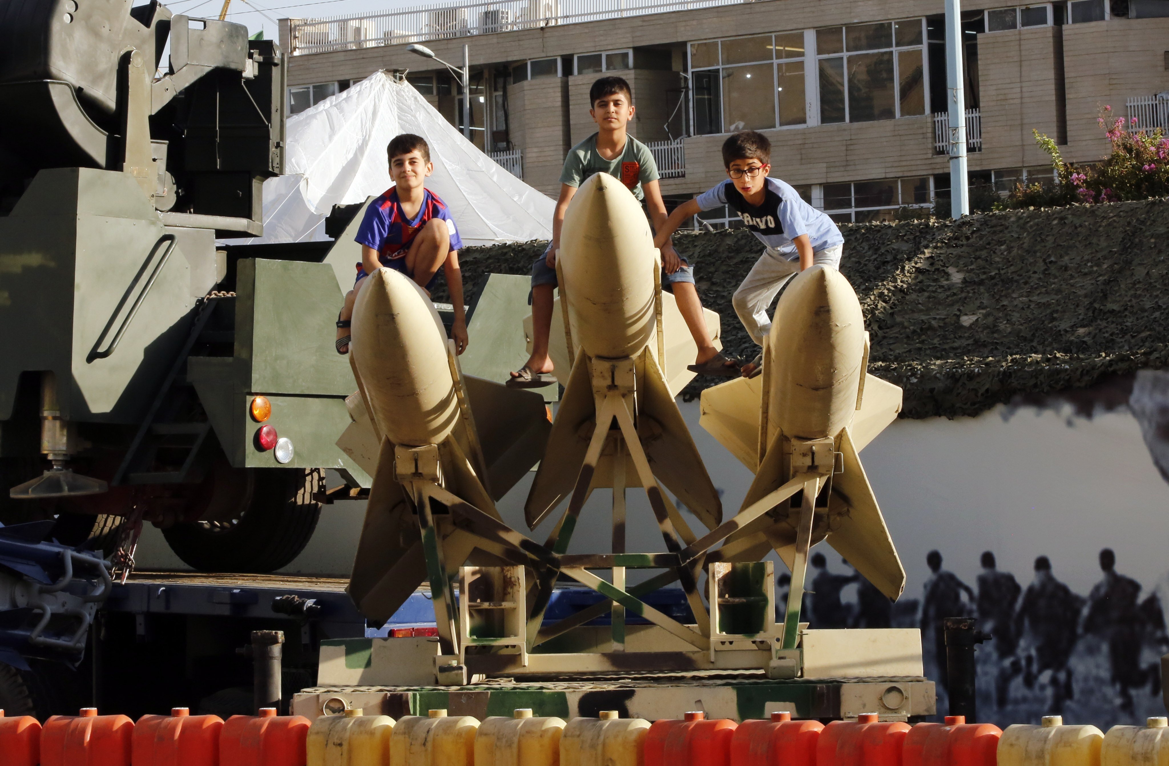 Iranian children sit on short-range missiles in a street exhibition celebrating “Defence Week” at the Baharestan Square in Tehran, Iran, on September 25. Iranian nuclear negotiations are set to resume on November 29. Photo: EPA-EFE
