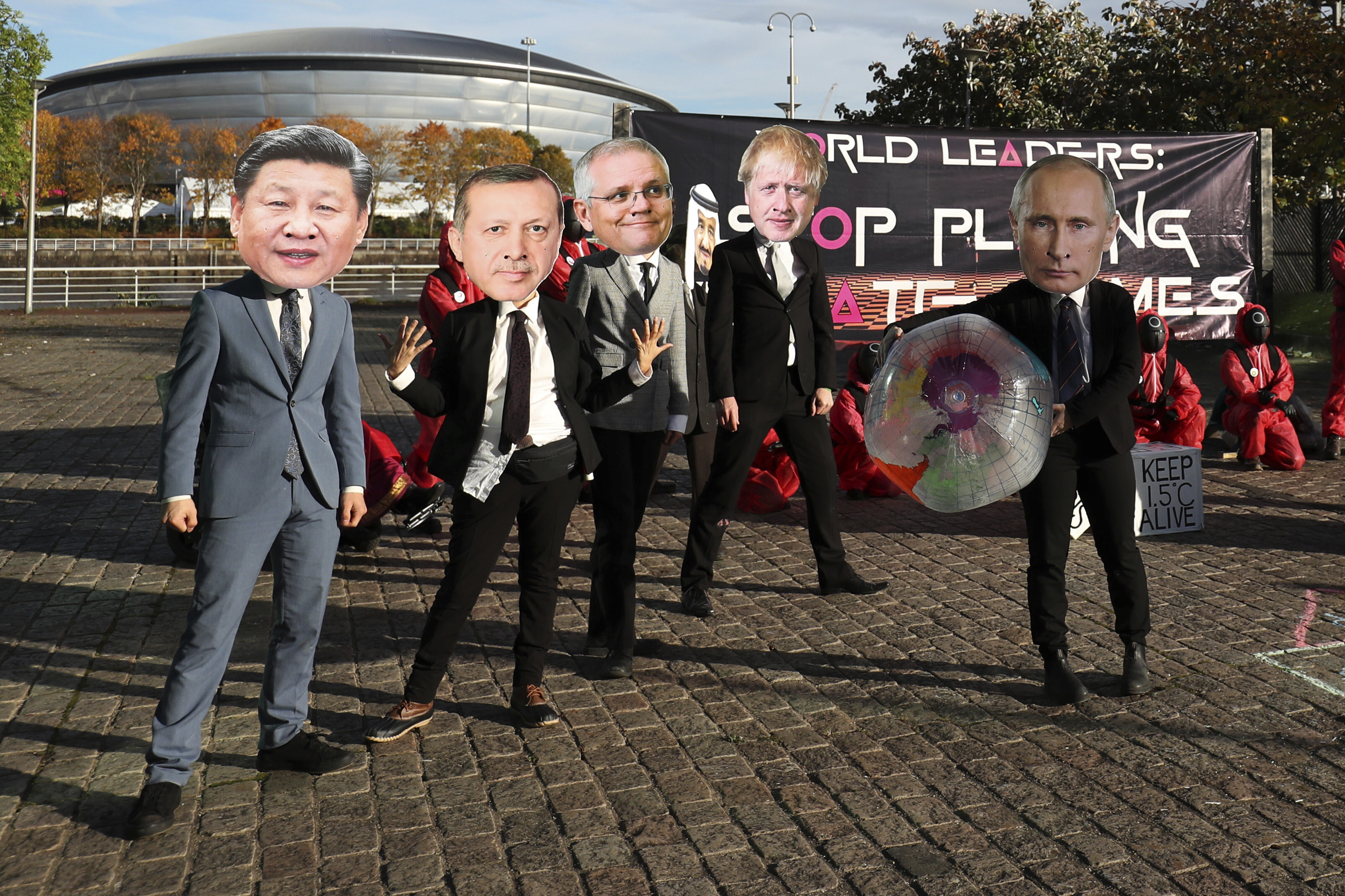 A Squid Game-themed demonstration with protesters wearing masks of world leaders outside COP26 in Glasgow on November 2. A good climate narrative needs villains and heroes, a believable political context, a moral theme and a riveting plot. Photo: AP