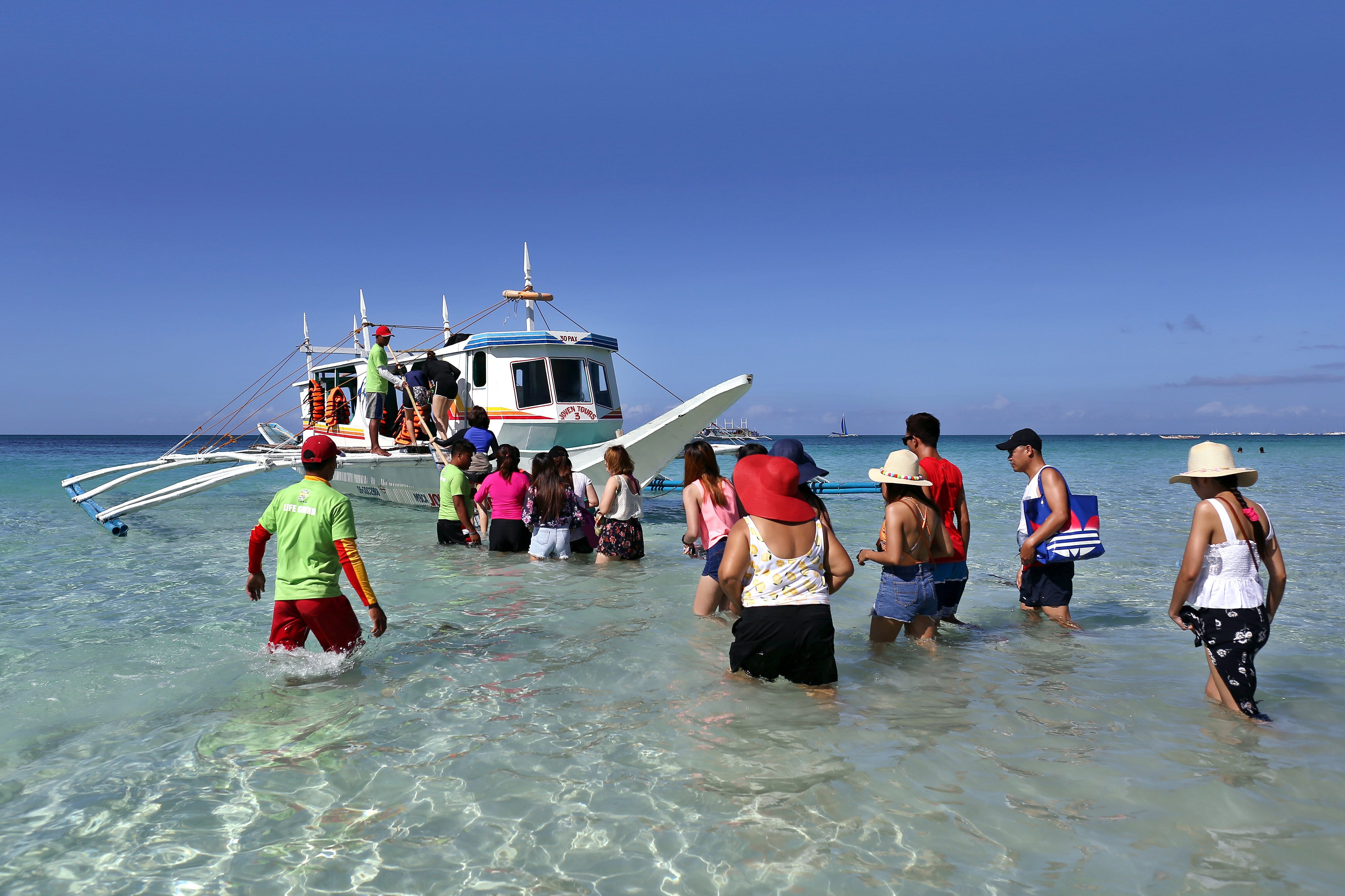 Tourists board a boat on a Boracay beach in the Philippines on December 10, 2018. More than 90 per cent of tourism workers have been fully vaccinated in the country’s tourism-dependent destinations such as Boracay, compared with only 30 per cent of the country as a whole. Photo: Getty Images