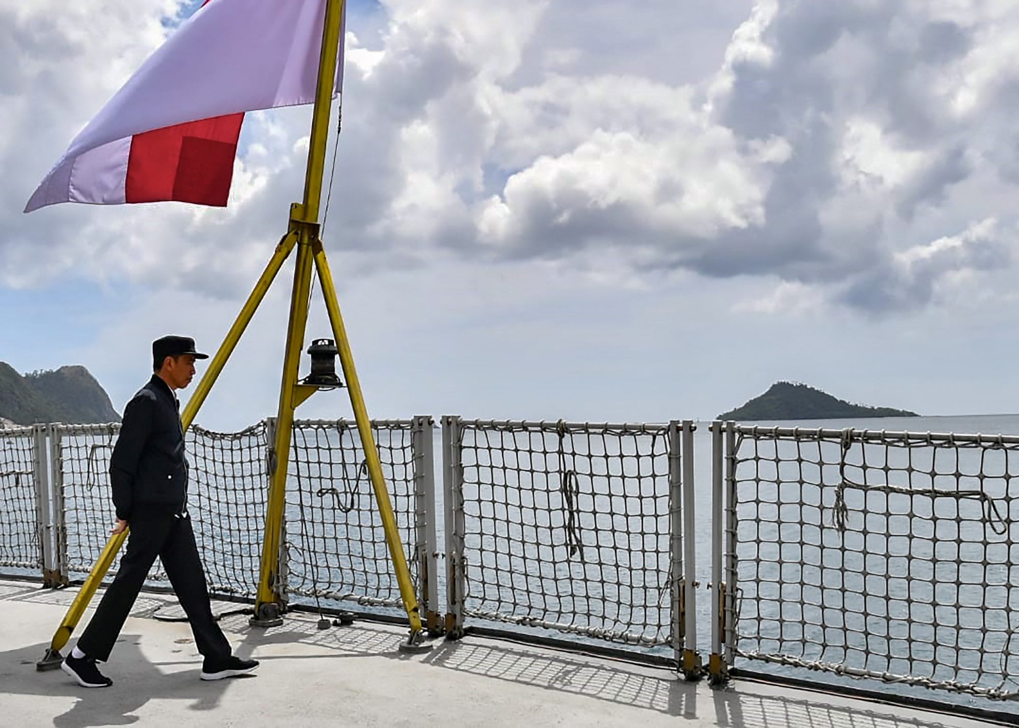 Indonesian President Joko Widodo walks on a navy ship during a visit to a military base in the Natuna Islands. Photo: AFP