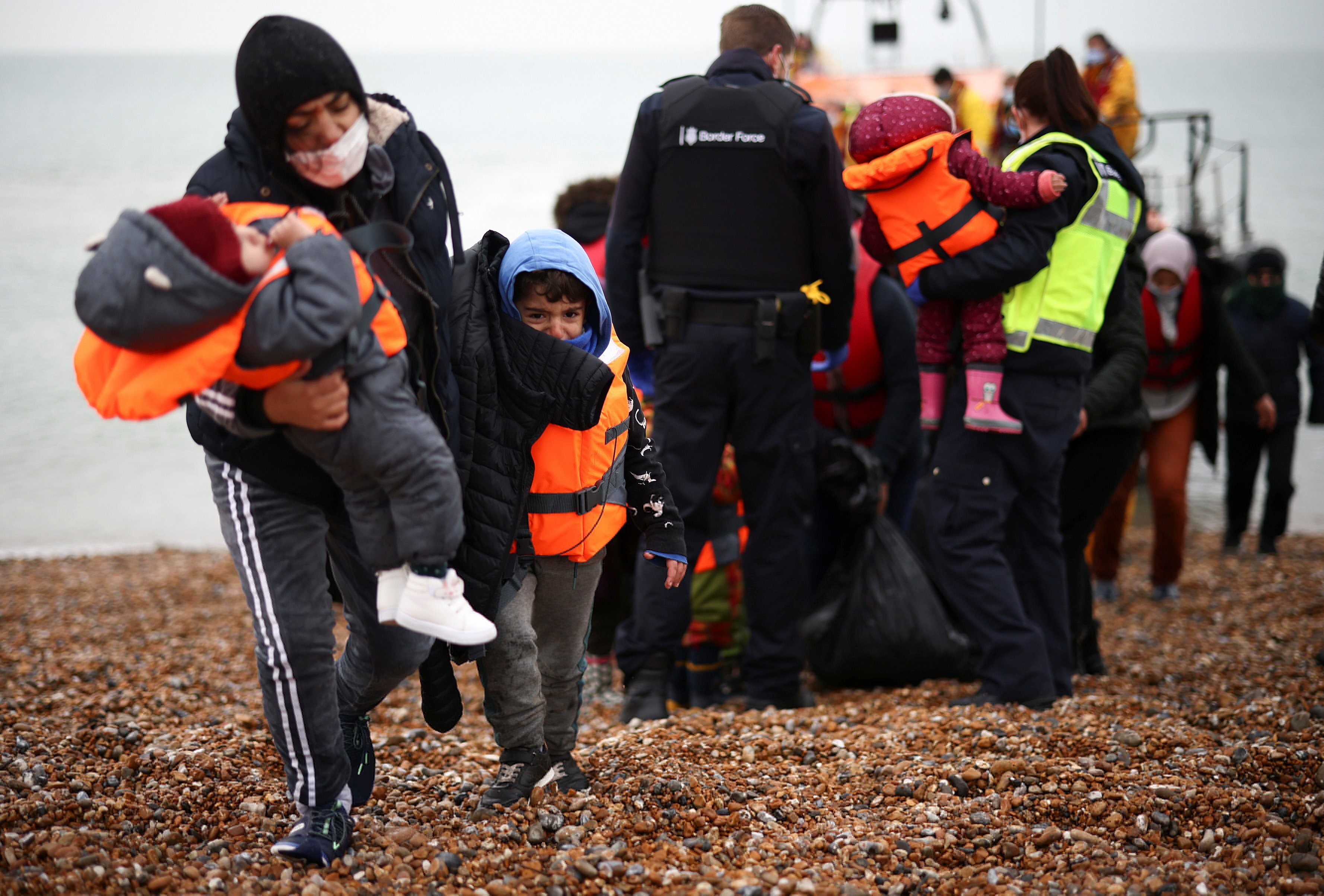 Migrants were brought ashore  in Dungeness, Britain by a RNLI lifeboat after crossing the Channel on Wednesday. Photo: Reuters