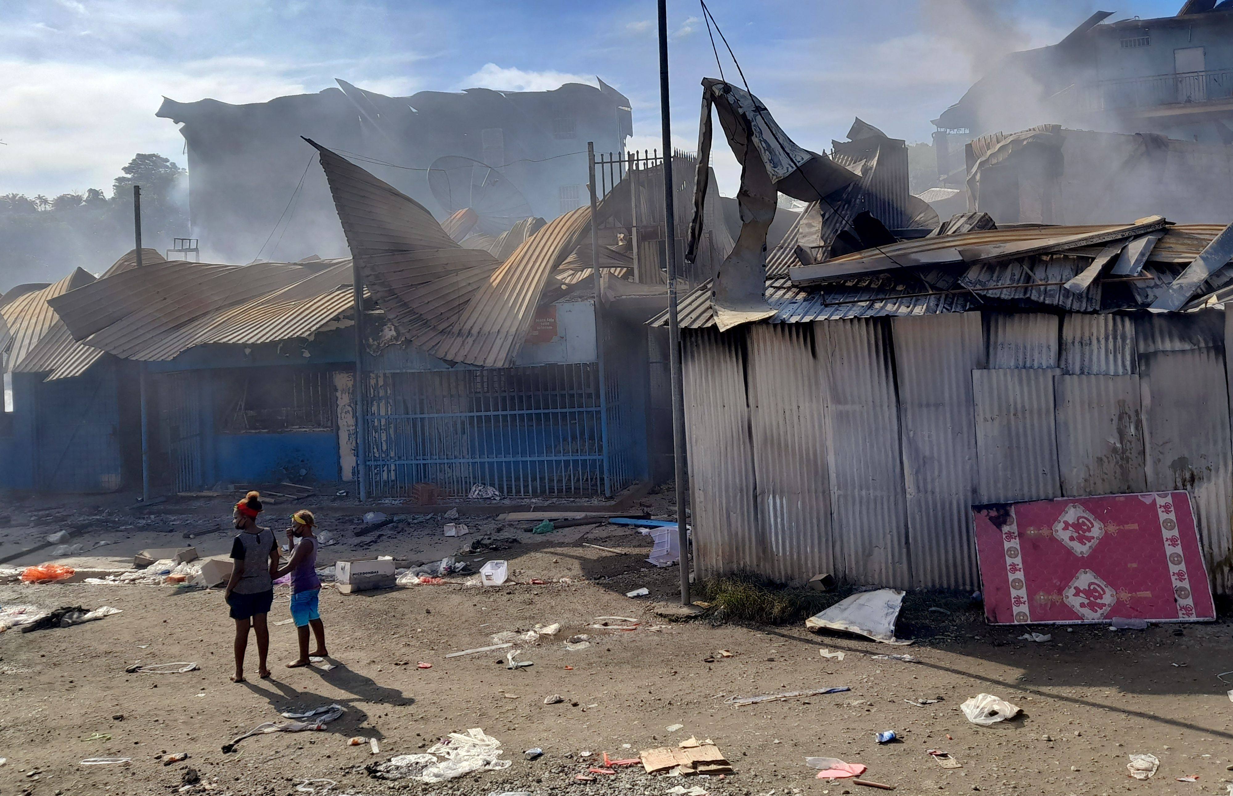 Smoke rises from a burnt out buildings in Honiara’s Chinatown on Friday after two days of rioting. Photo: AFP