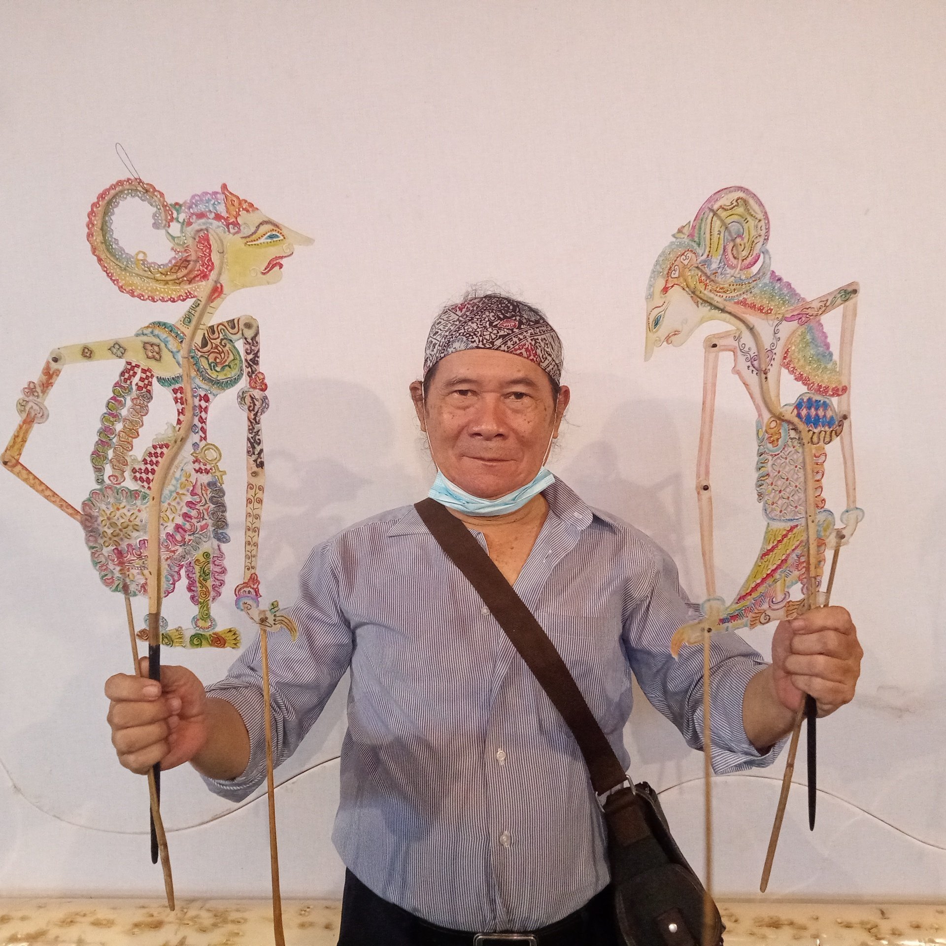 Ki Samidjan posing with his shadow puppets Betari Jaluwati, left, and Warya Bissunanda. Photo: Handout