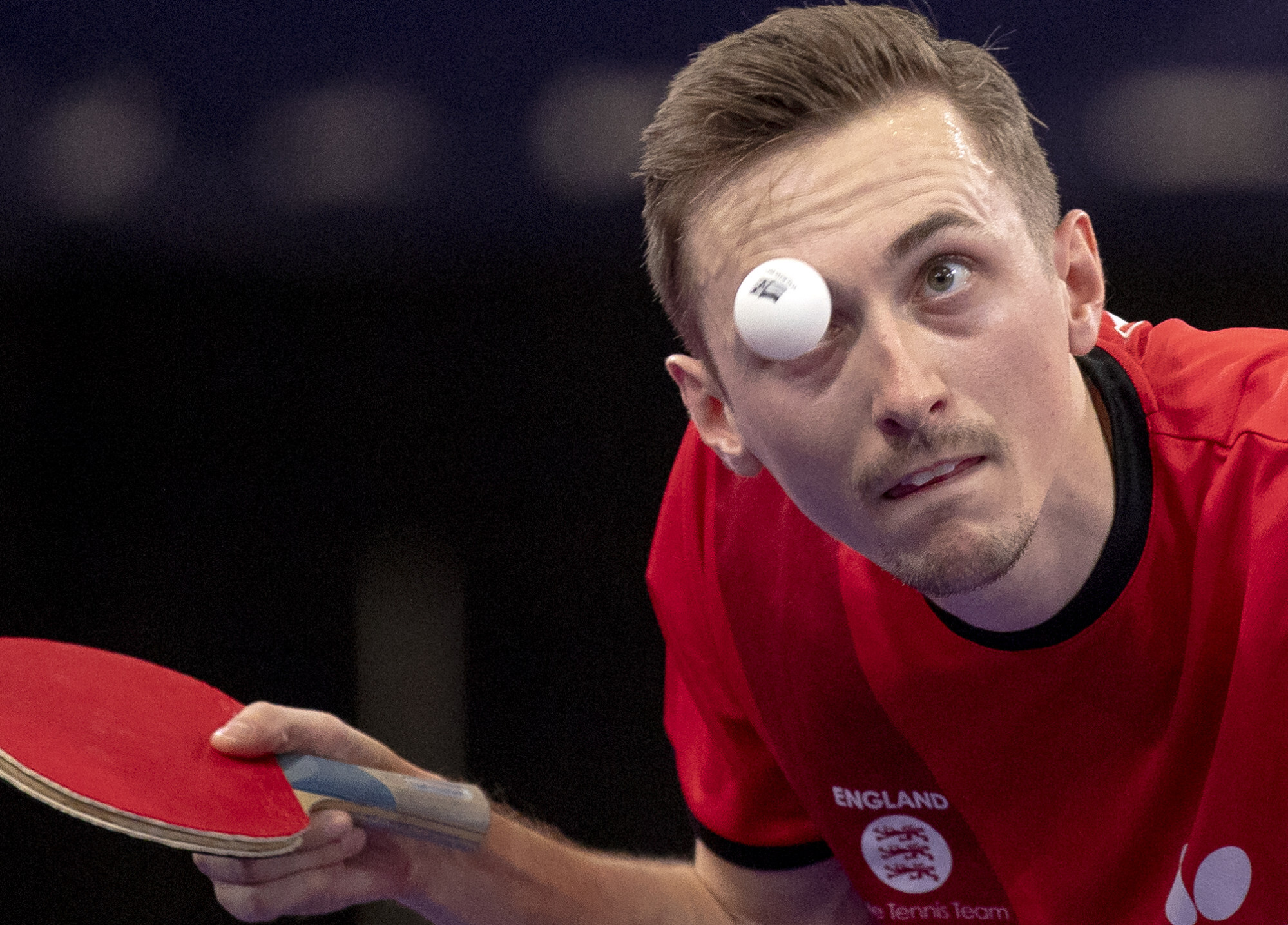Table tennis player strikes bowling pins with ping-pong balls