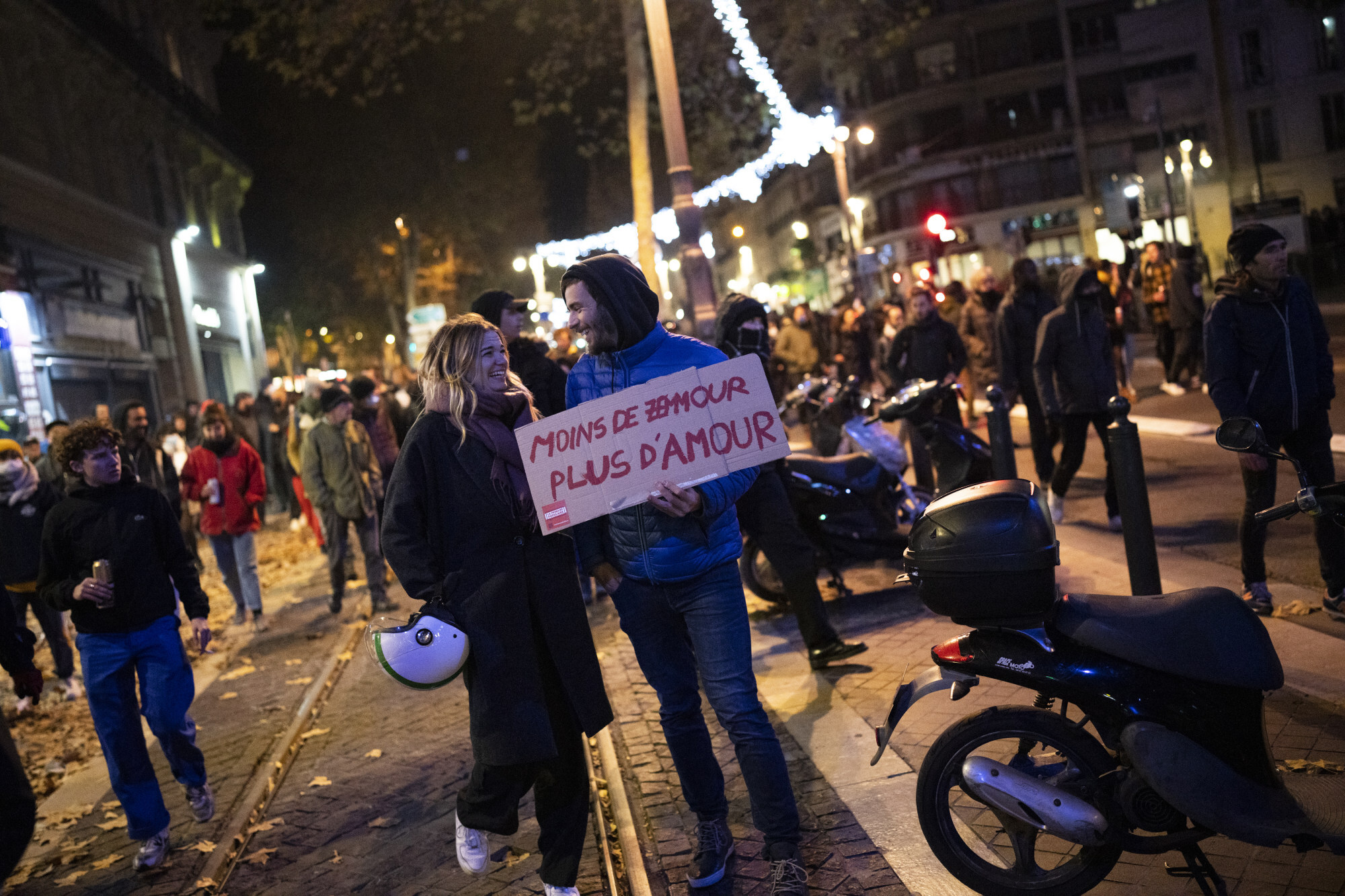 Protesters hold a sign that reads “Less Zemmour, more Love” during a demonstration against political talk show star Eric Zemmour, in Marseille. Photo: AP