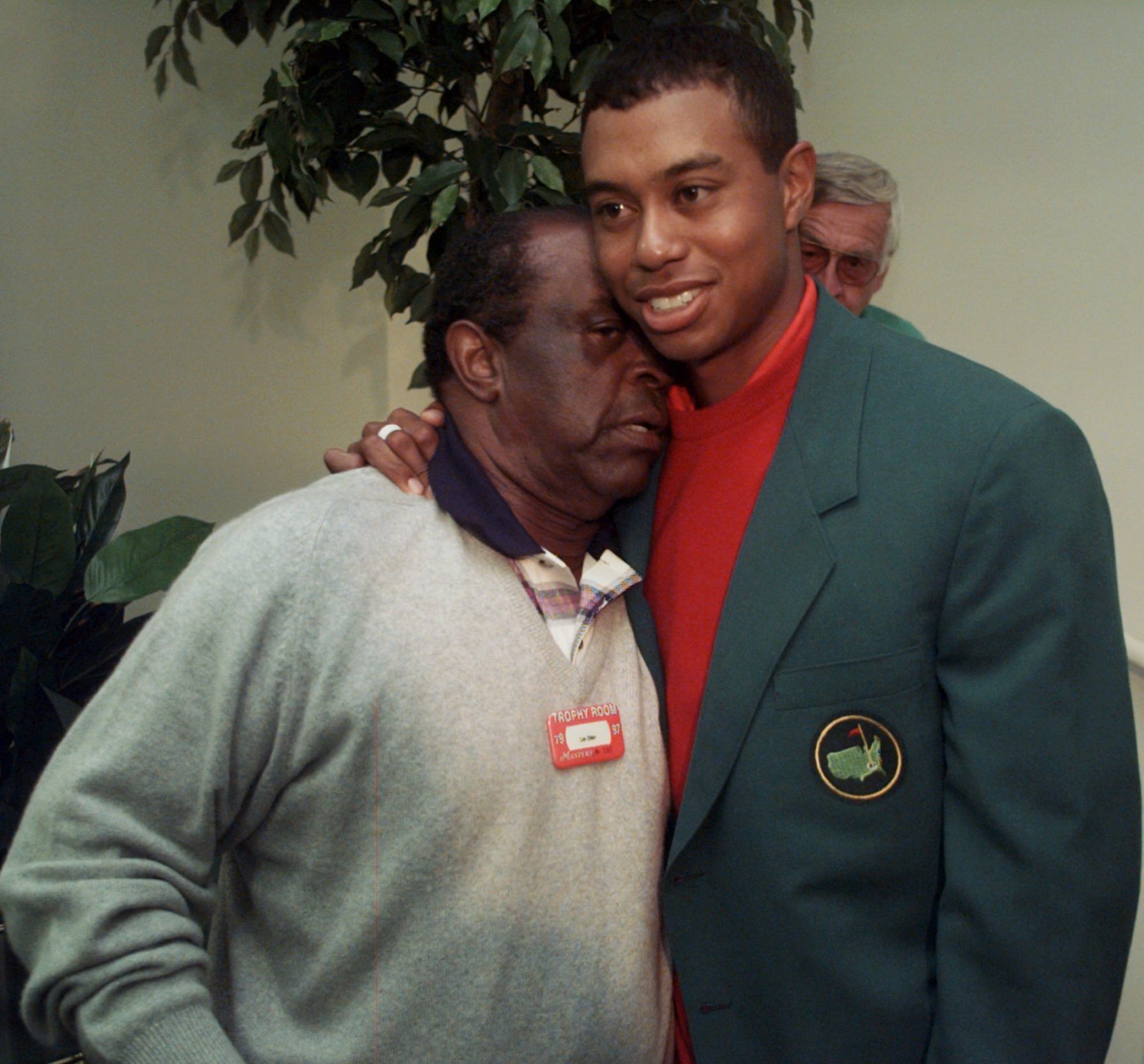 Masters champion Tiger Woods gets a hug from Lee Elder after winning the tournament for the first time in 1997. Photo: AP