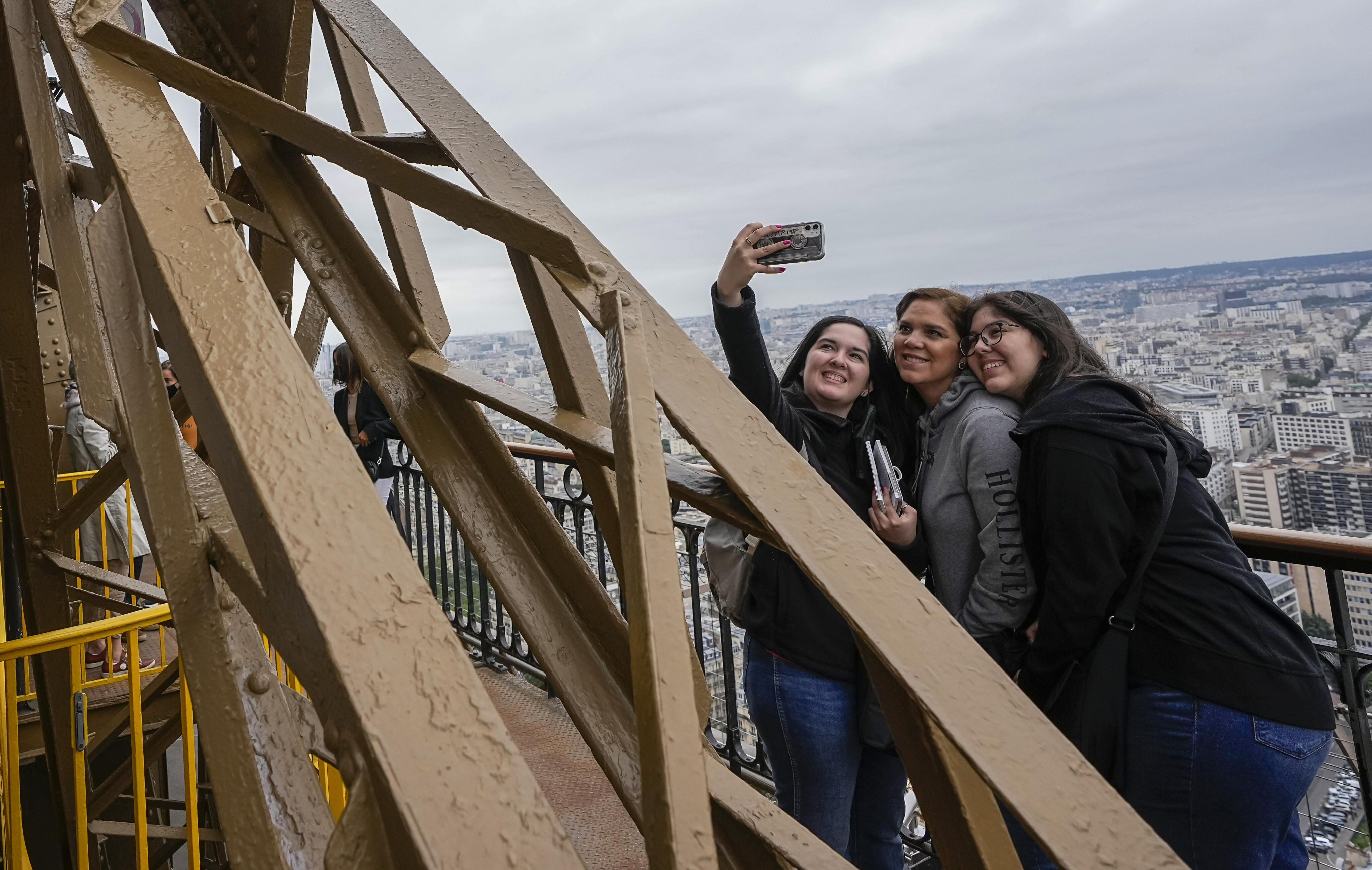 Visitors take a selfie at the Eiffel Tower in Paris, which topped the tourist destination index. Photo: AP 
